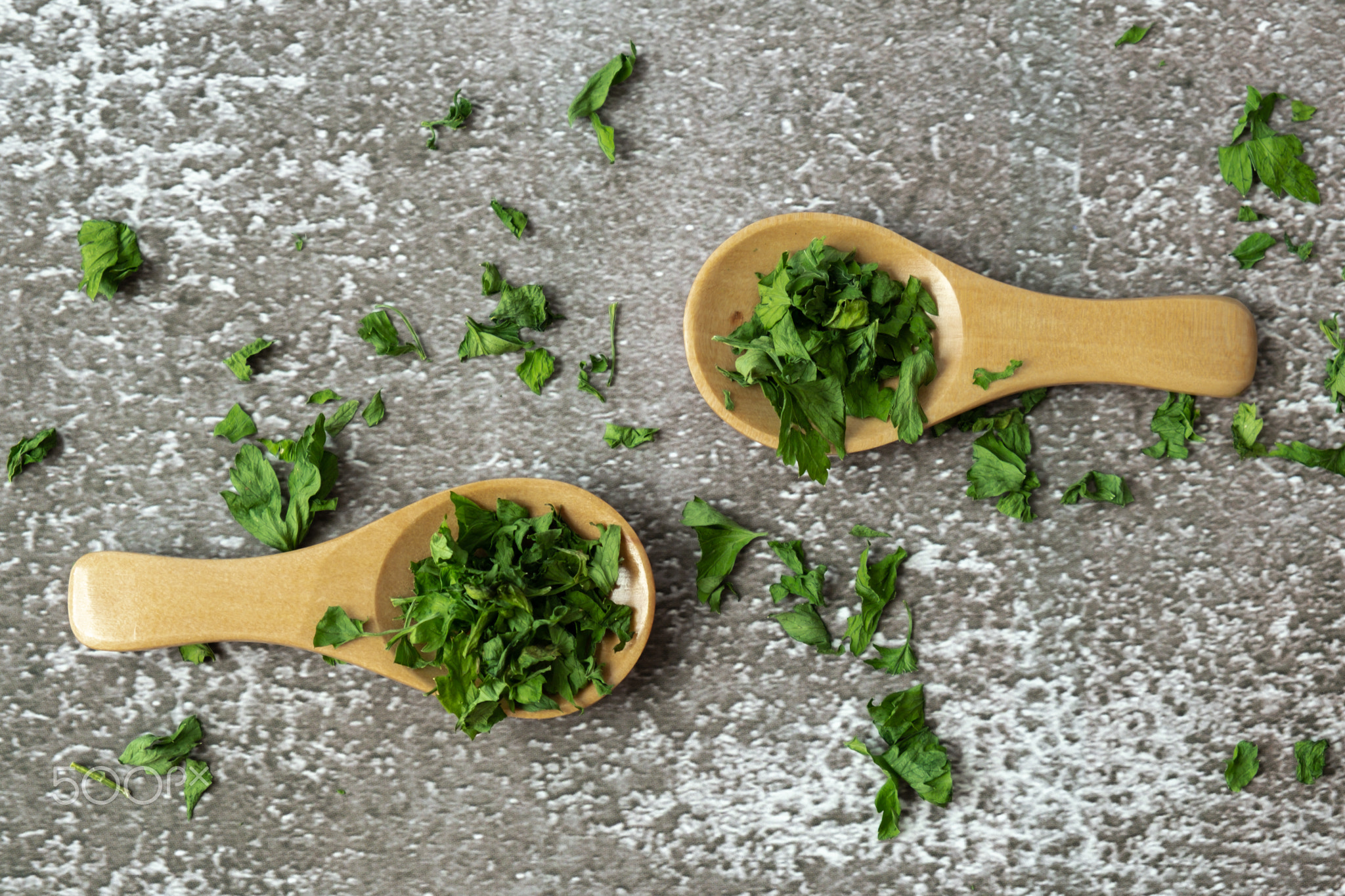 Wooden spoon with green dry parsley. Vegetarian bio organic salad herb
