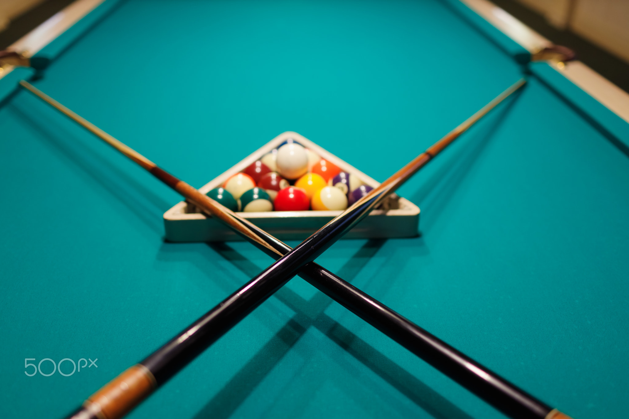 Billiard accessories balls and cue on a billiard table
