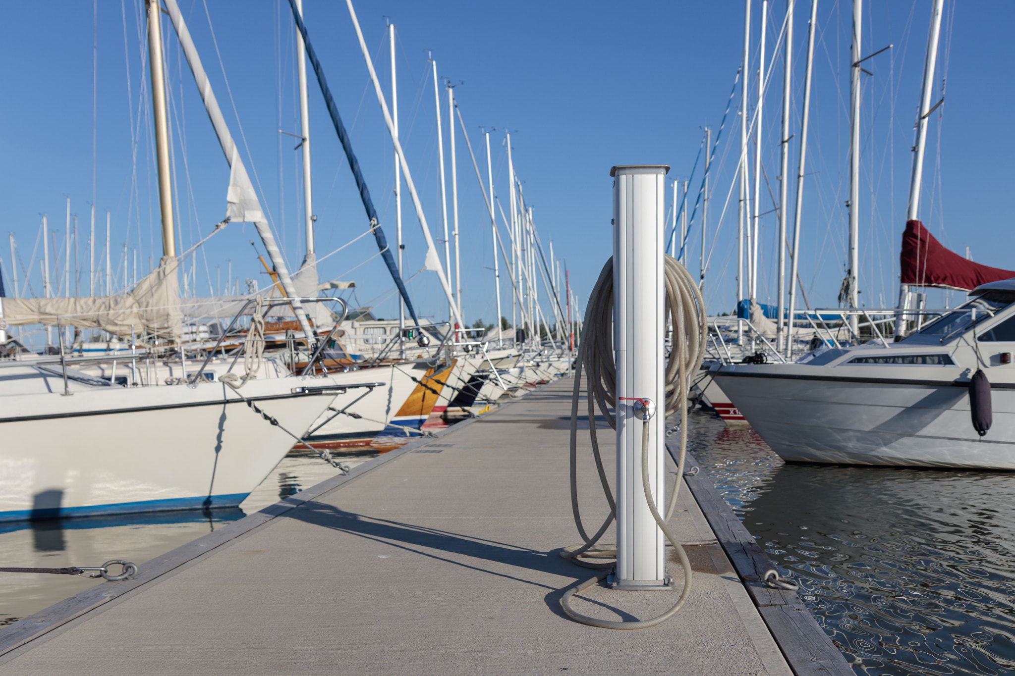 Charging and water station for boats, electrical outlets to charge ships in harbor, water vent and h