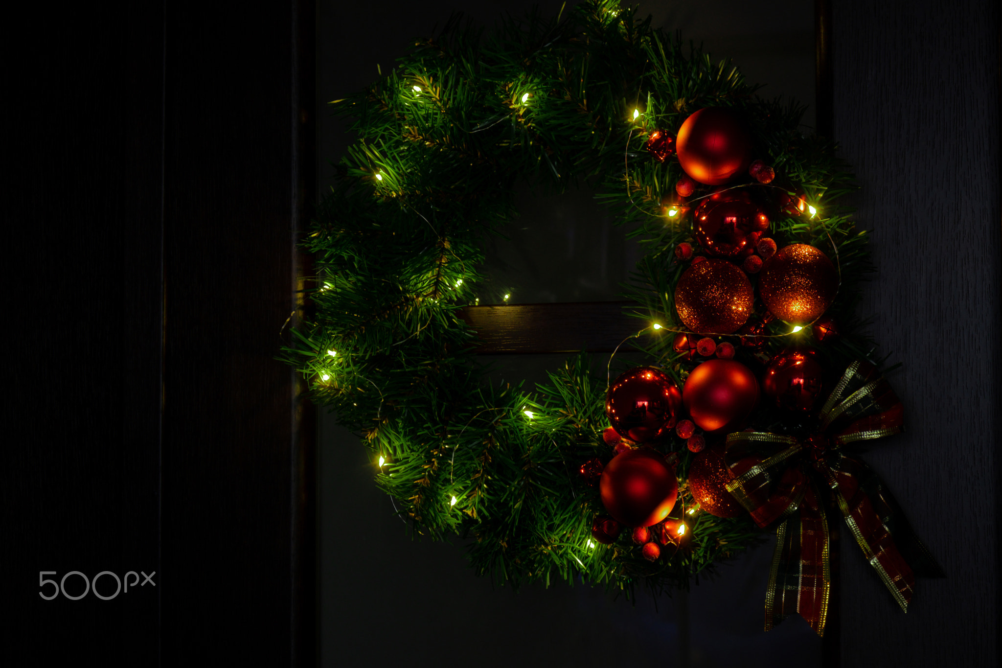 Handmade Christmas wreath from festive red decorations. Festive