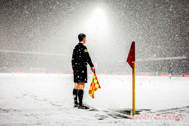 A linesman stands in the snow.