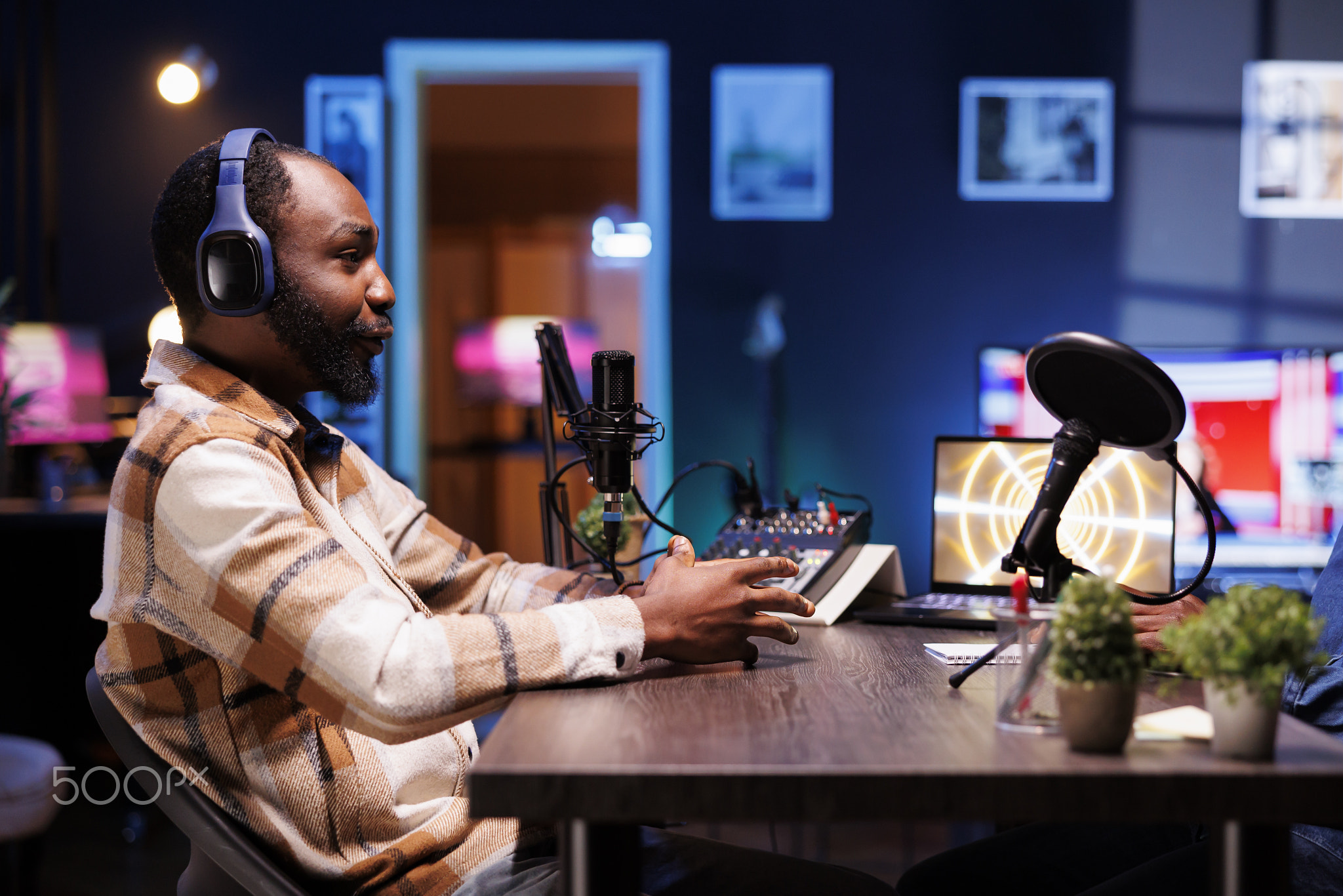 Man with headphones speaking into mic
