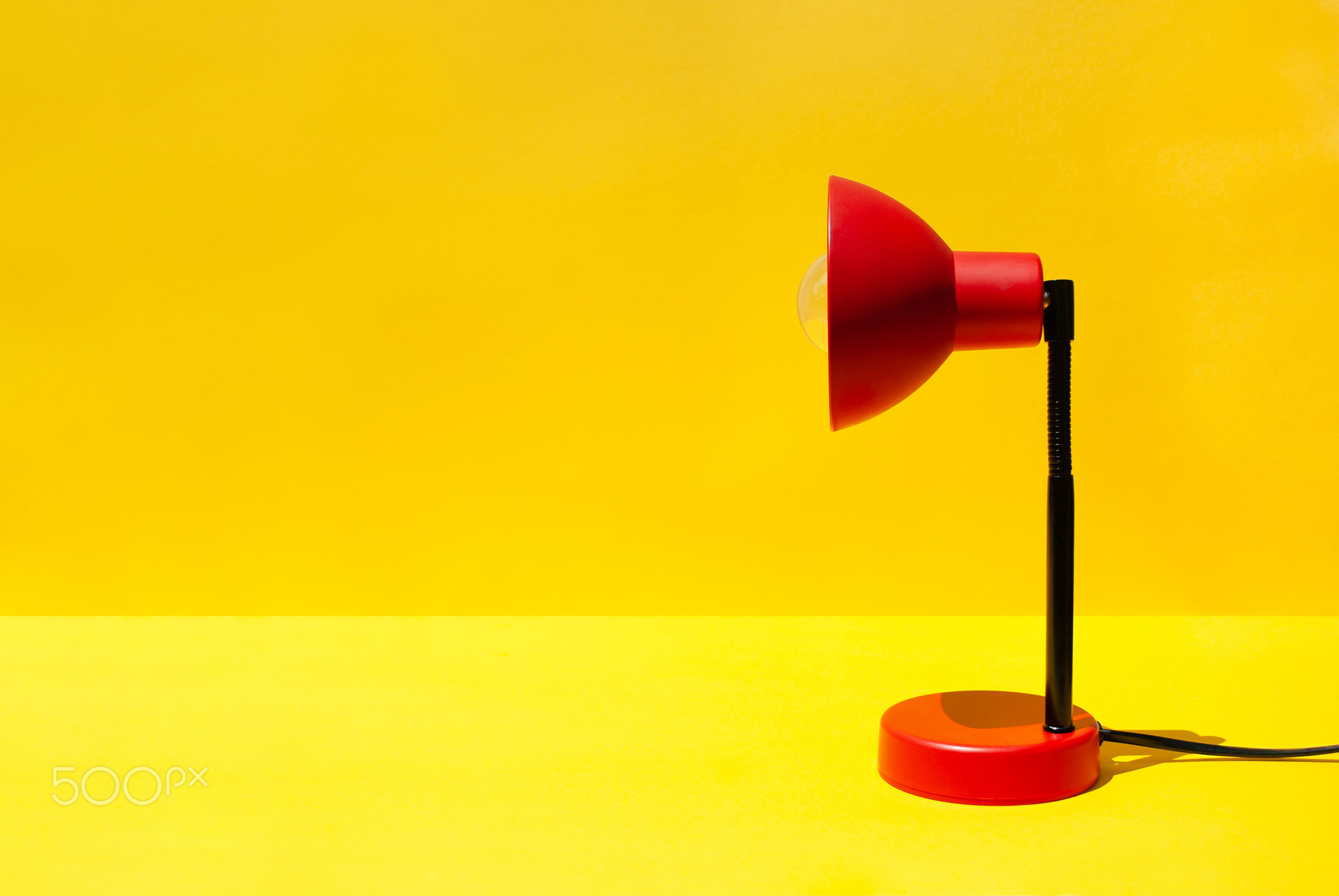 Red lamp on table in room with copy space