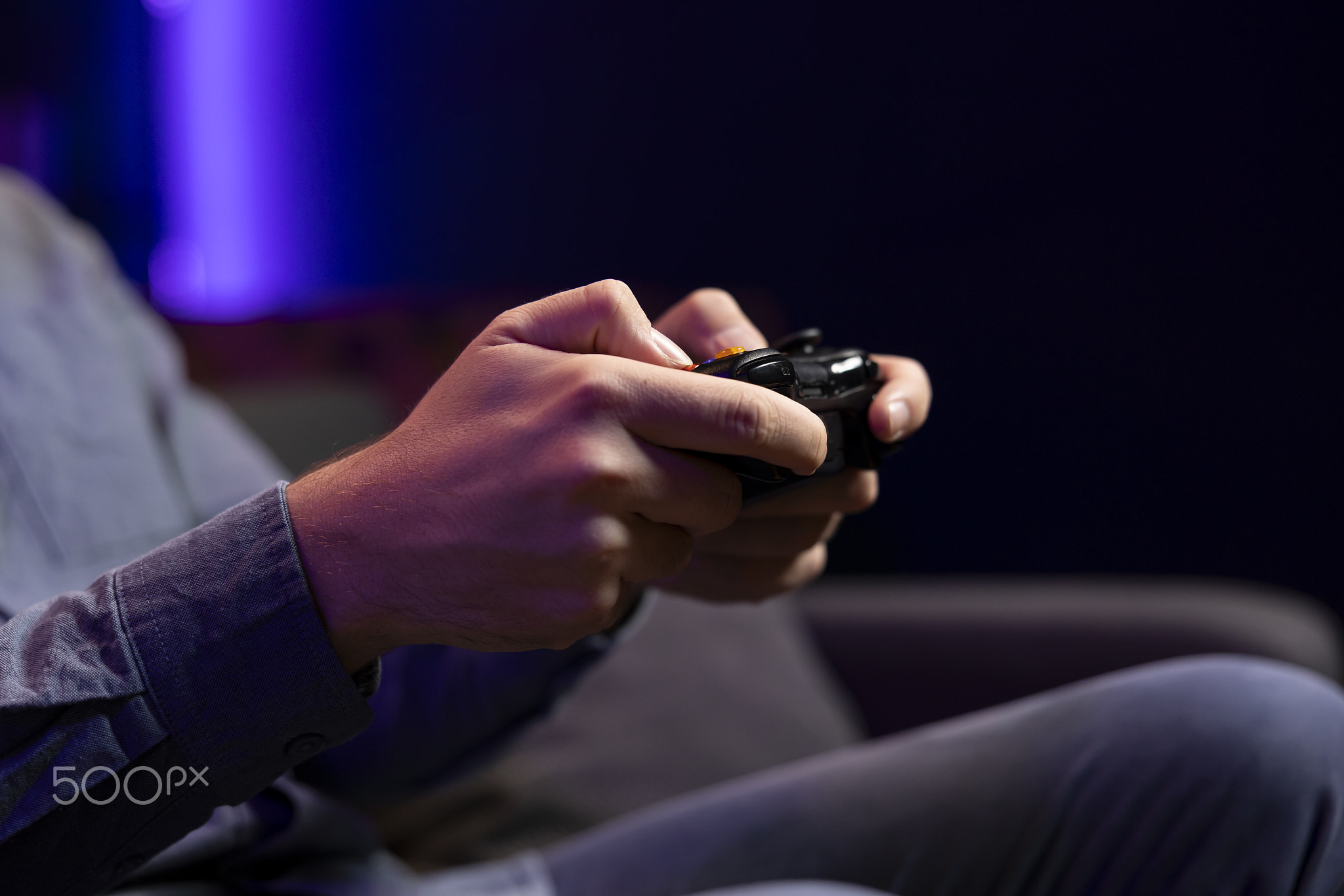 Close up shot of gamepad controller in man hands playing online