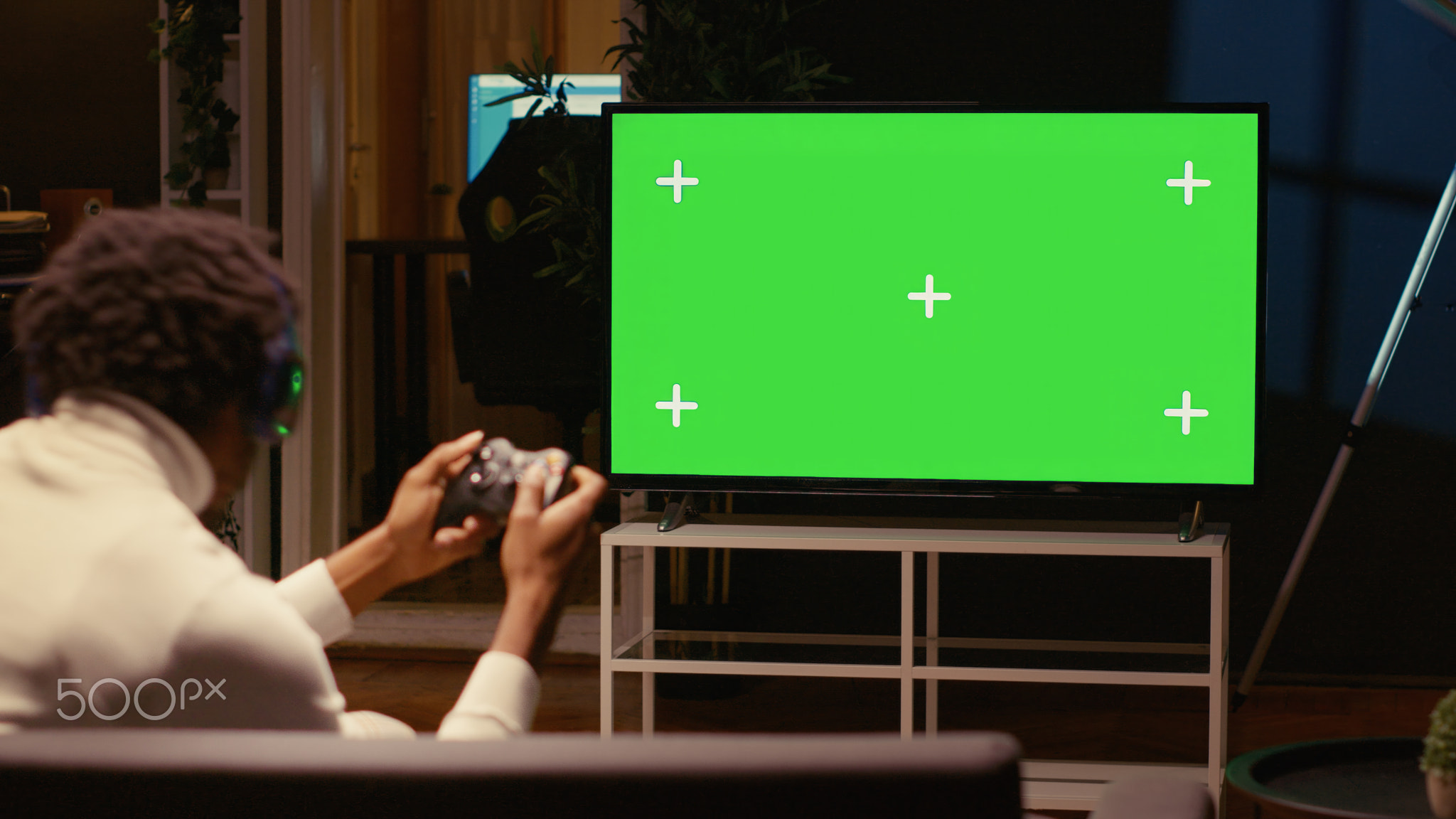 Gamer battling enemies in online multiplayer shooter on mockup gaming