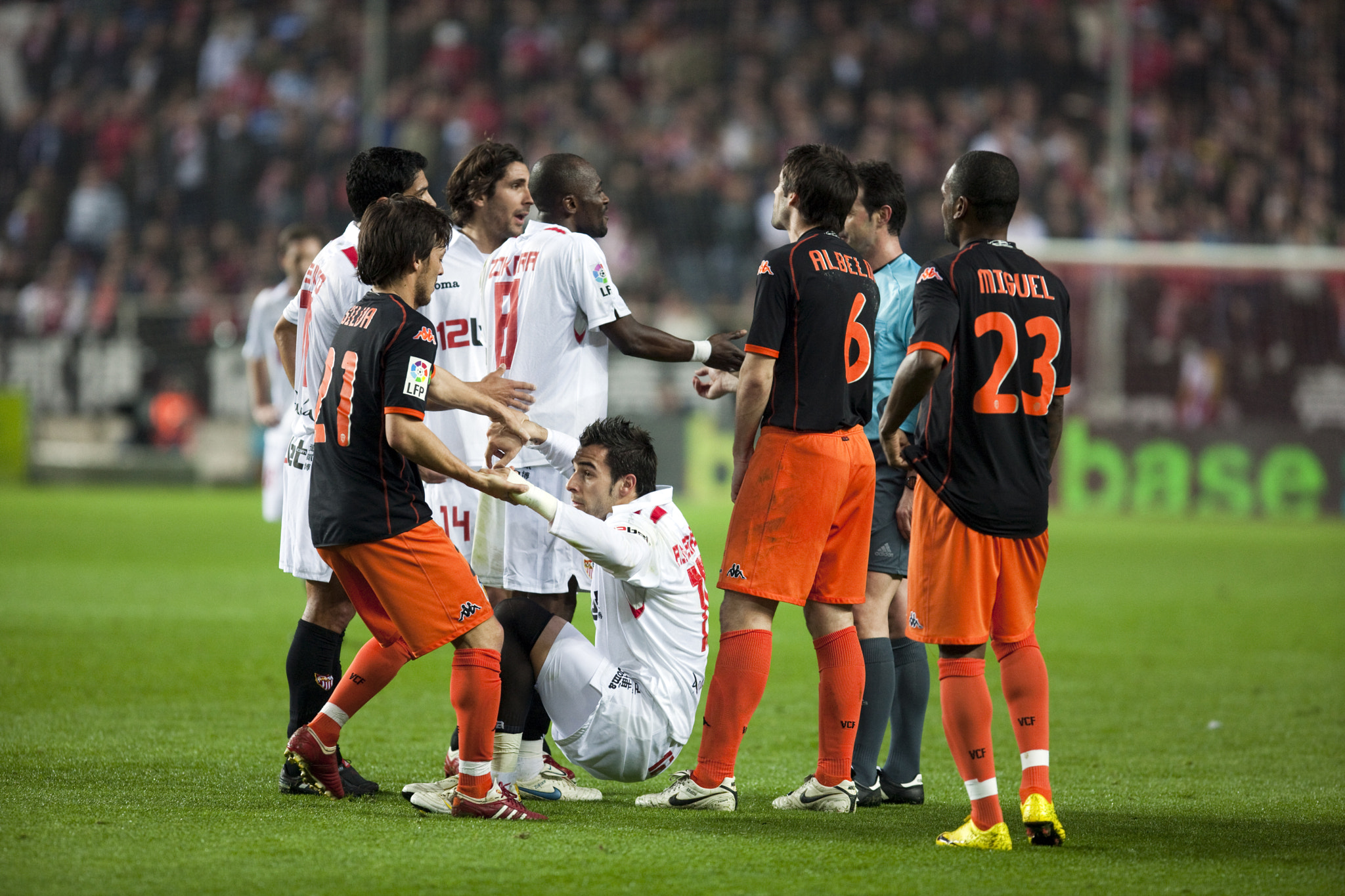 Silva helps Negredo to get up among other players. Spanish Liga game between Sevilla FC and Valencia