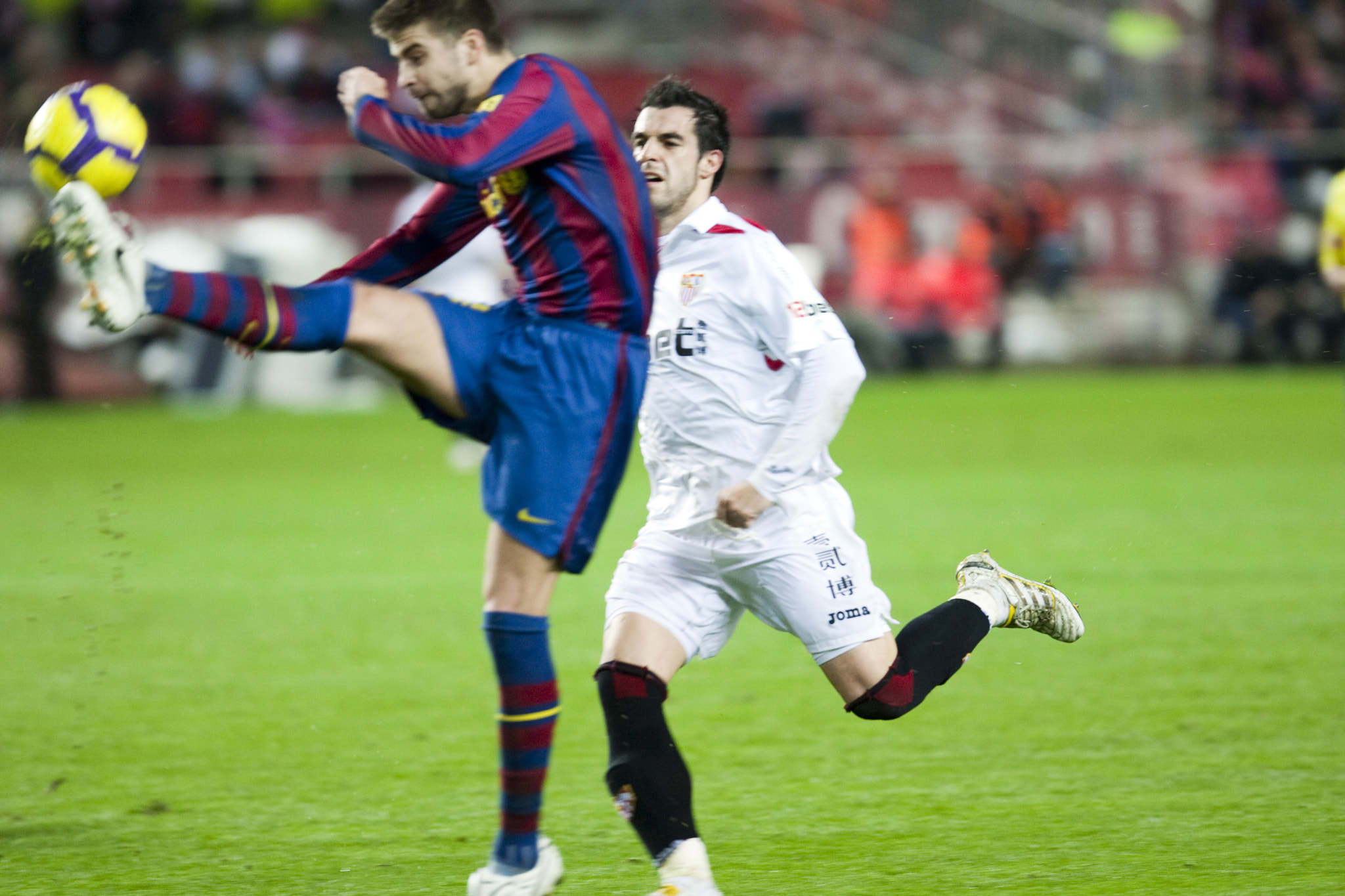 Pique kicking the ball before Negredo. Spanish Cup game between Sevilla FC and FC Barcelona, Ramon S