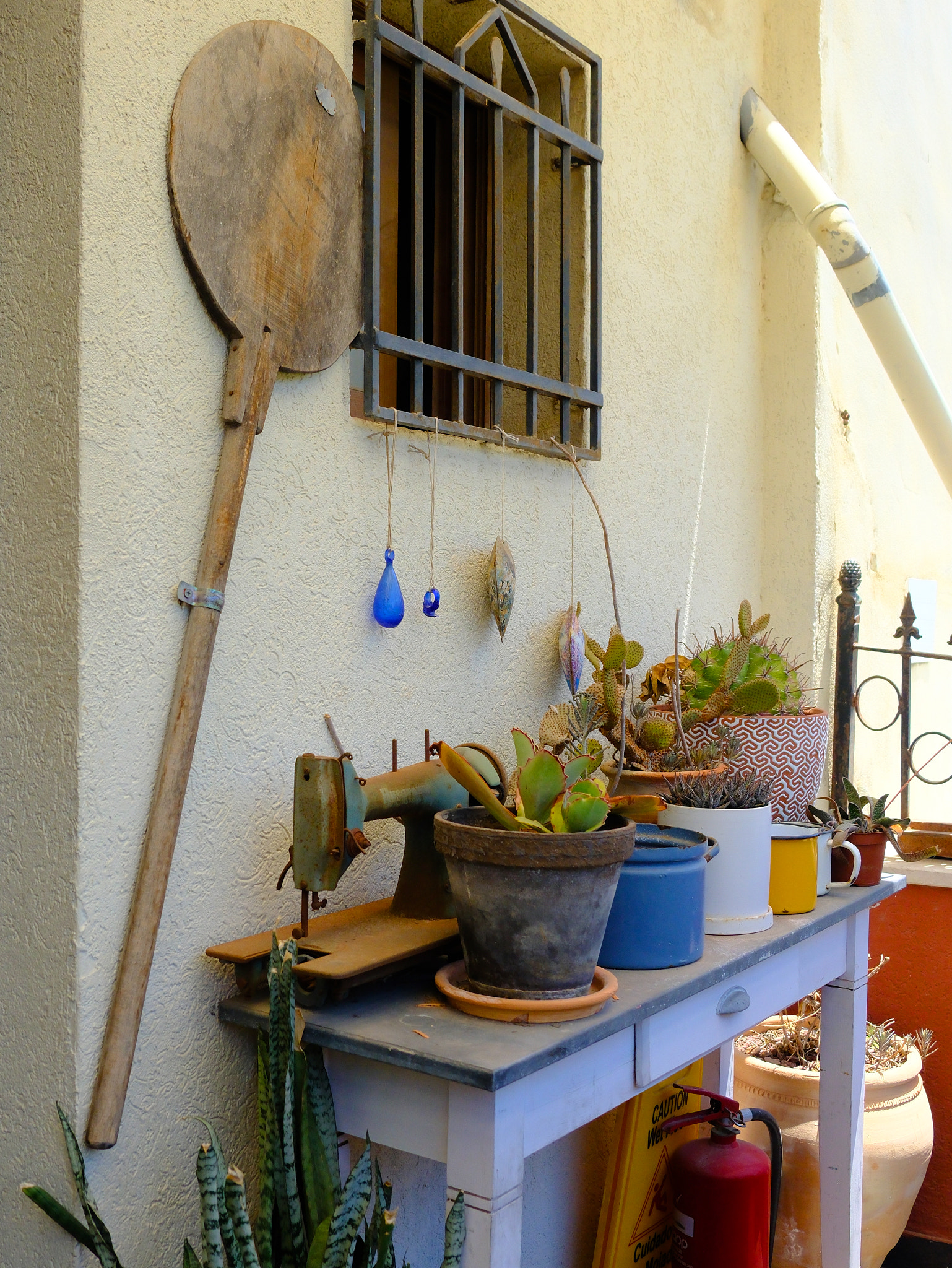 Quaint corner with rustic items and plants by a window, exuding a cozy vintage vibe perfect for quai