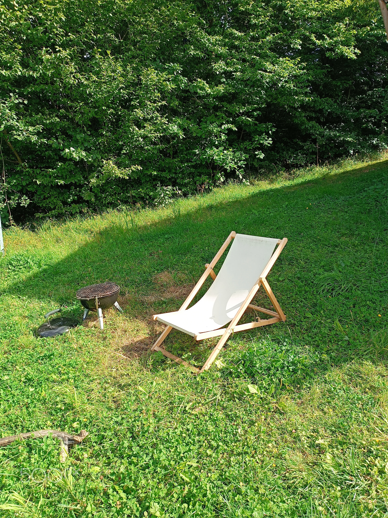 white beach deck canvas chair on the green grass with grill leisure picnic time