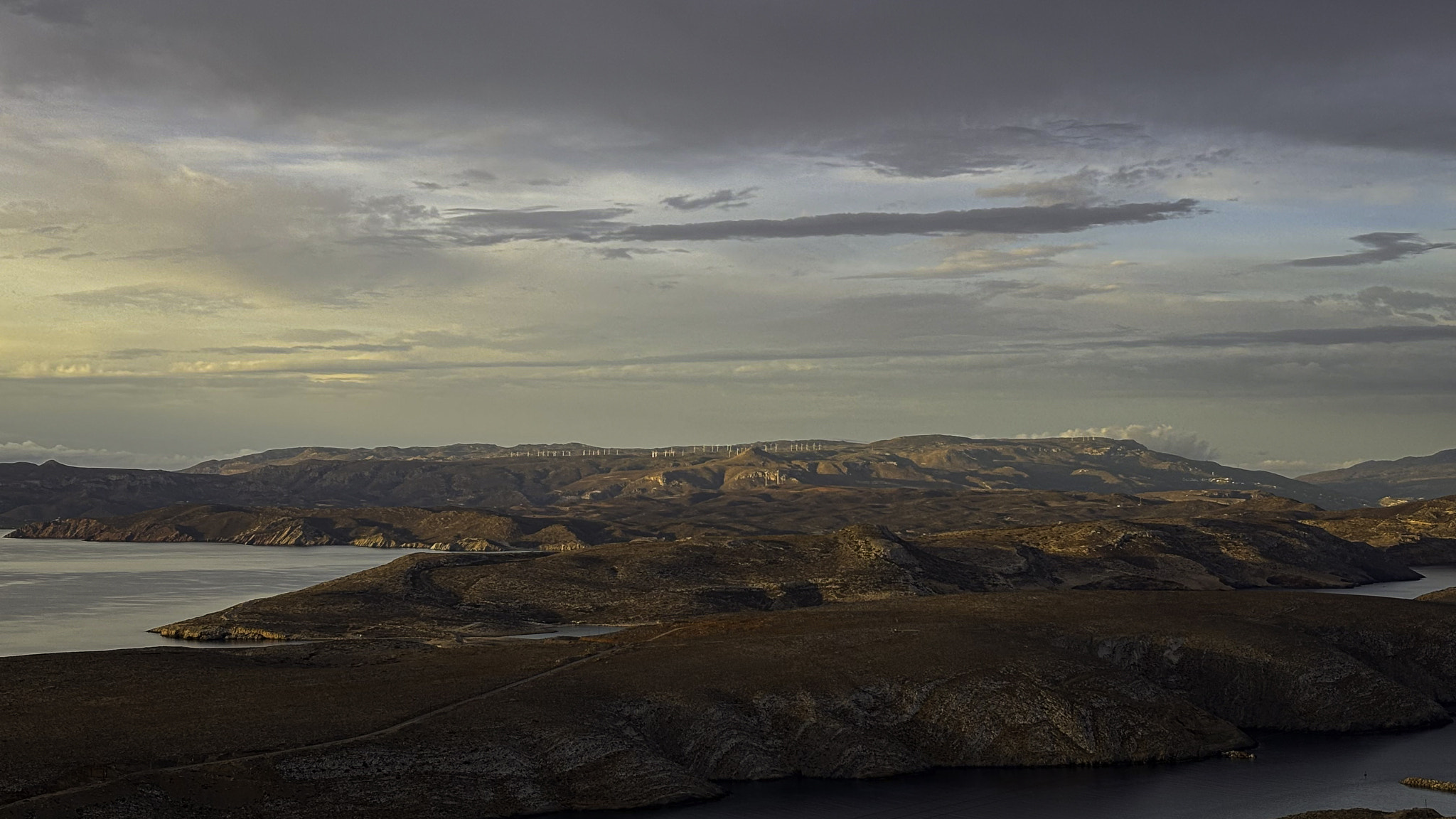 Scenic view of sea and mountains against sky