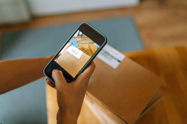 Cropped hands of woman photographing parcel at home by Olha Dobosh on 500px.com