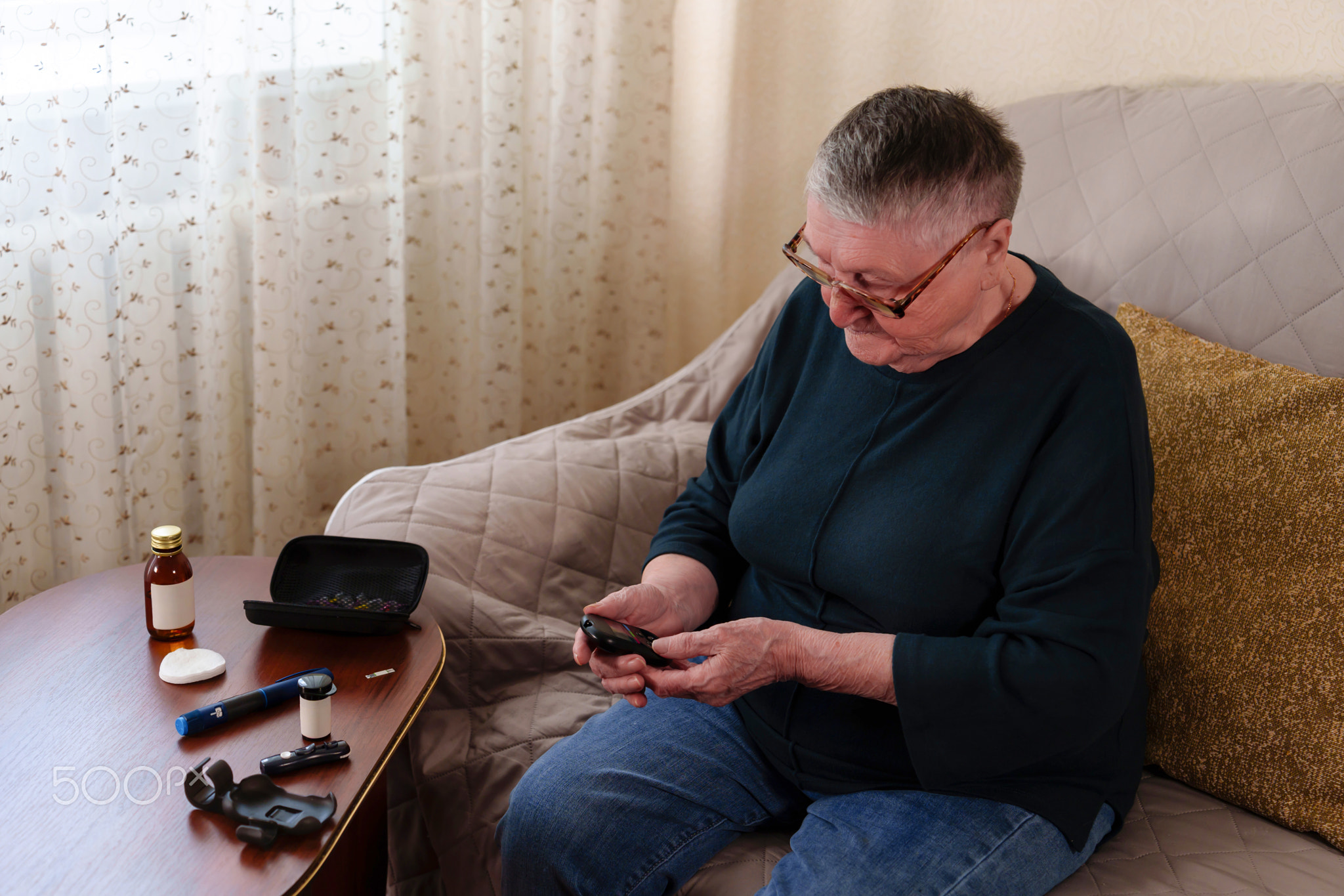 senior grandmother, her gray hair and glasses perched on her nose, intently focuses on the