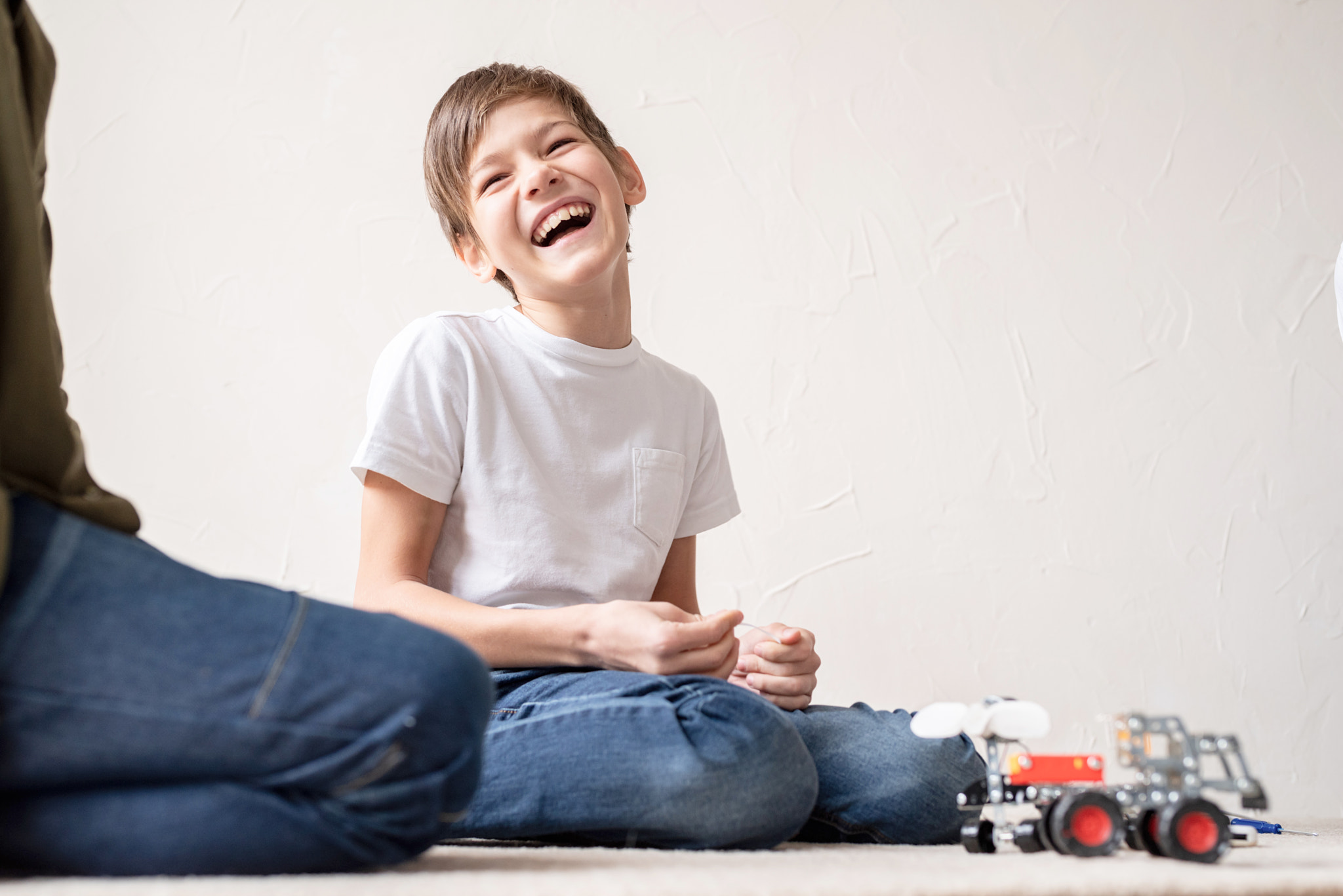 Young boys having fun constructing robot cars at the workshop