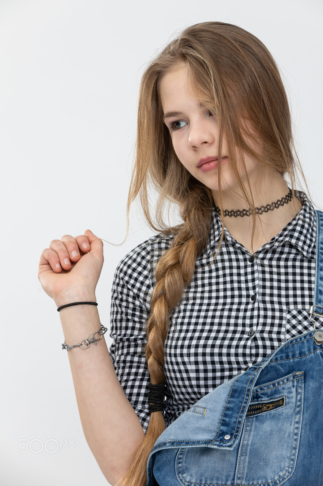 Young girl poses for a photo against a white background