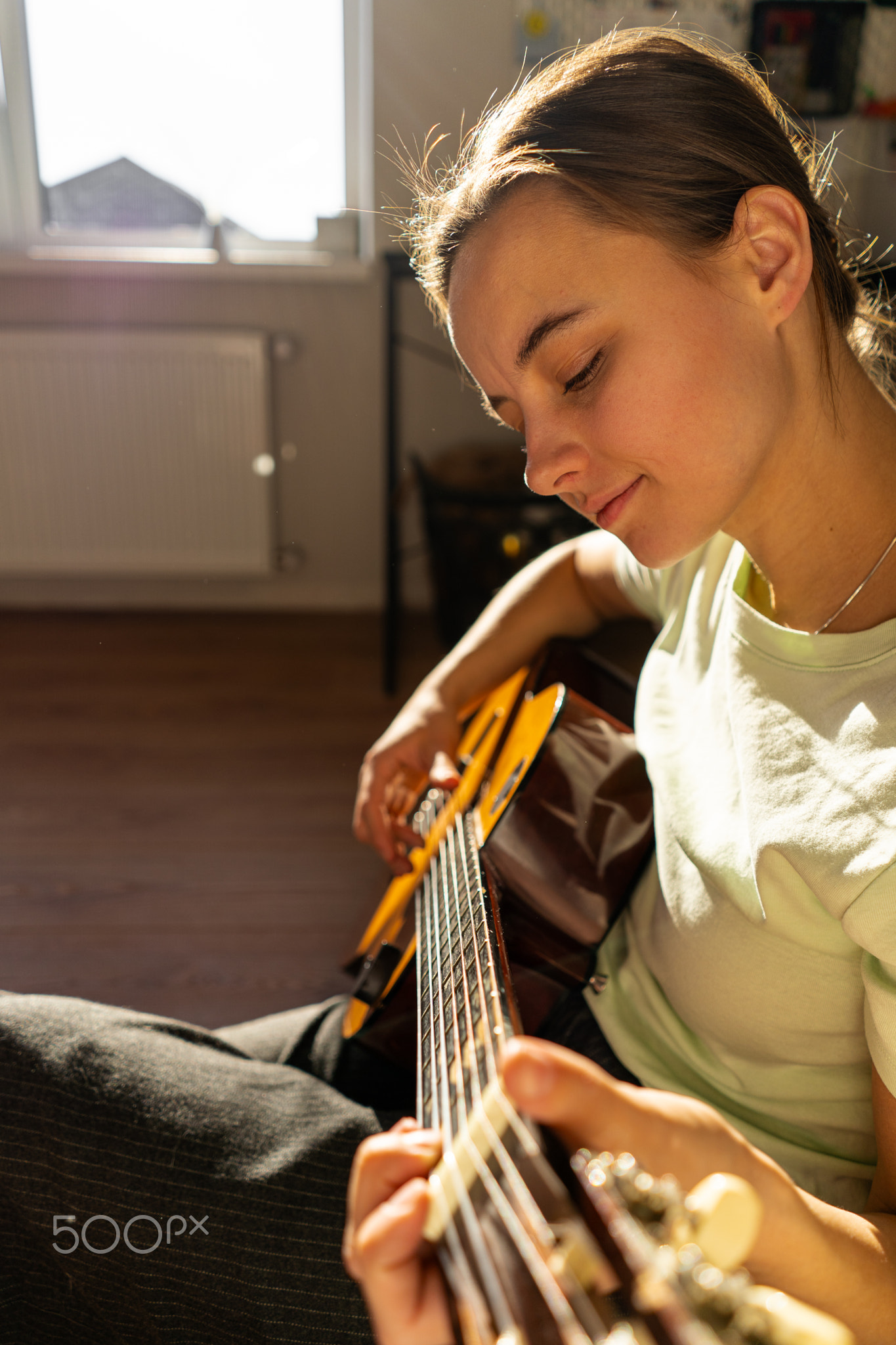 A woman playing a guitar