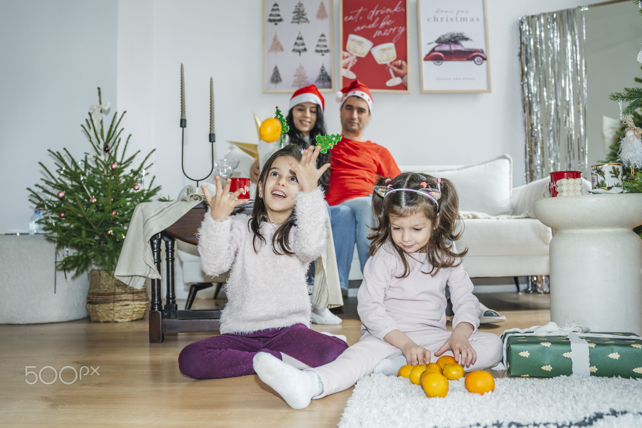 Children lighting sparklers near a festive Christmas tree. Happy moments of anticipation for