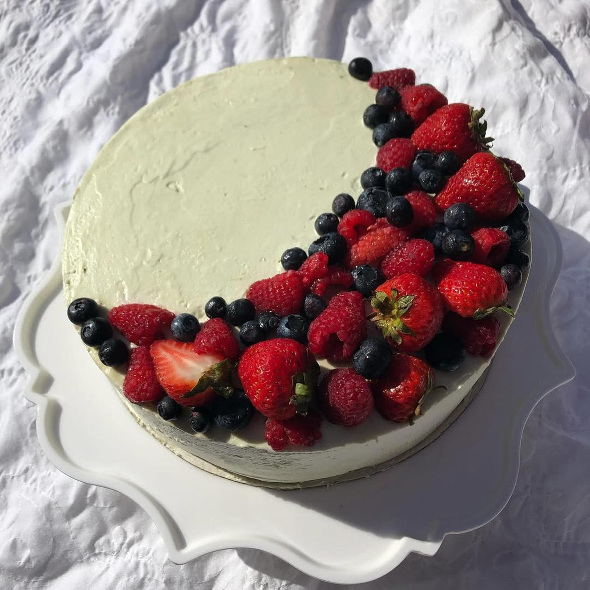 Artistic Berry Crescent Cake in White Plate