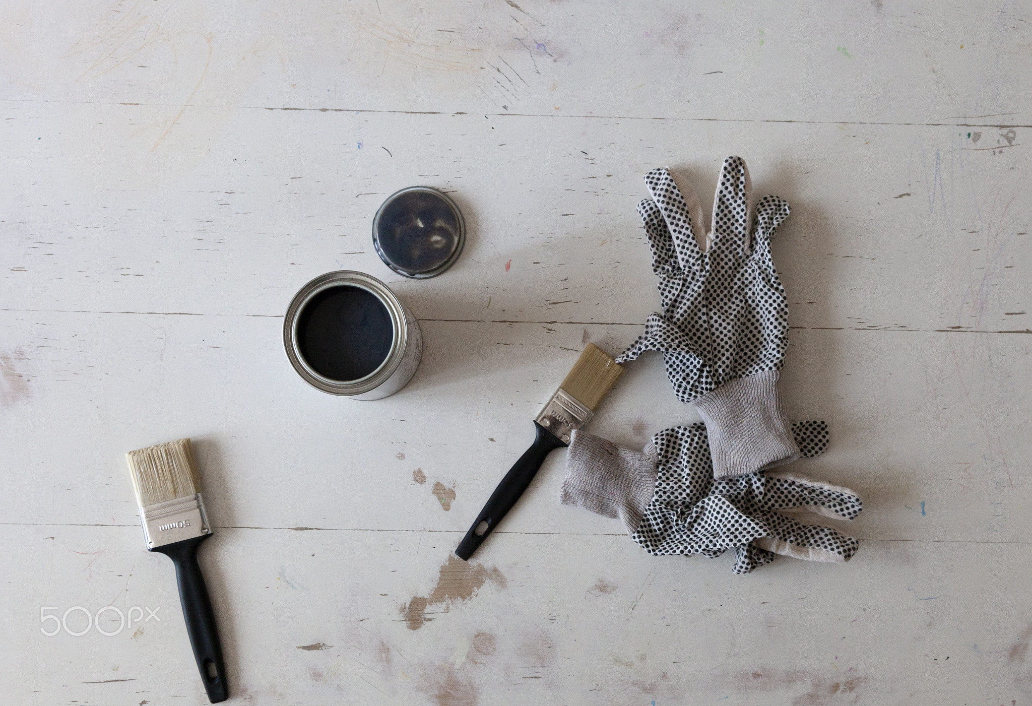 Top view of table renovation with brushes, paint and gloves. Flat Lay
