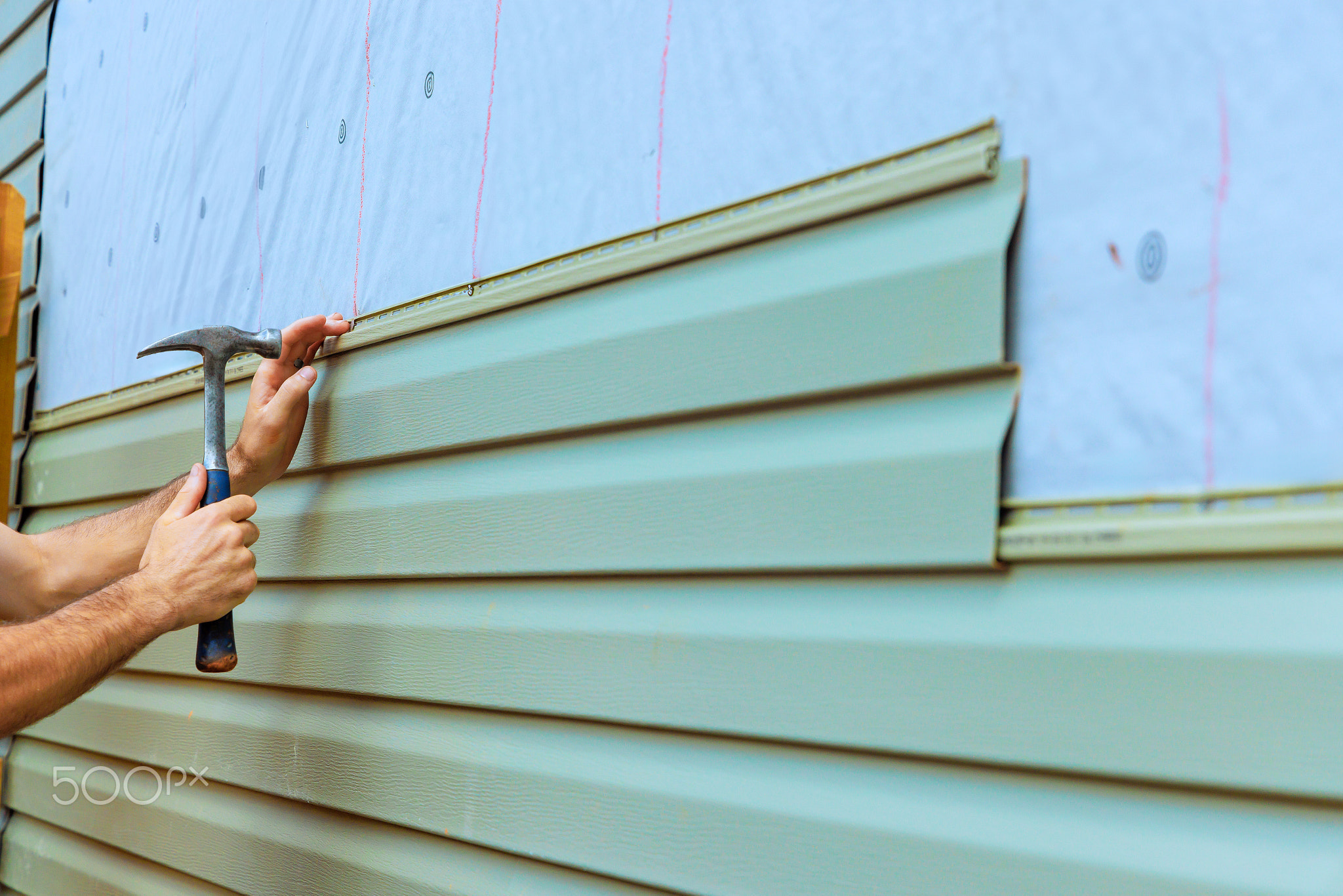 Home improvement project involves installing new siding on an exterior