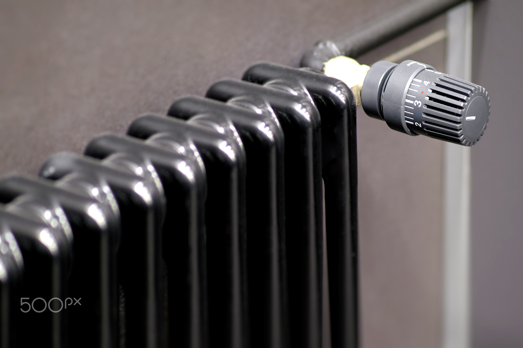 Contemporary Black Radiator Featuring an Adjustable Thermostat for Optimal Heating Control