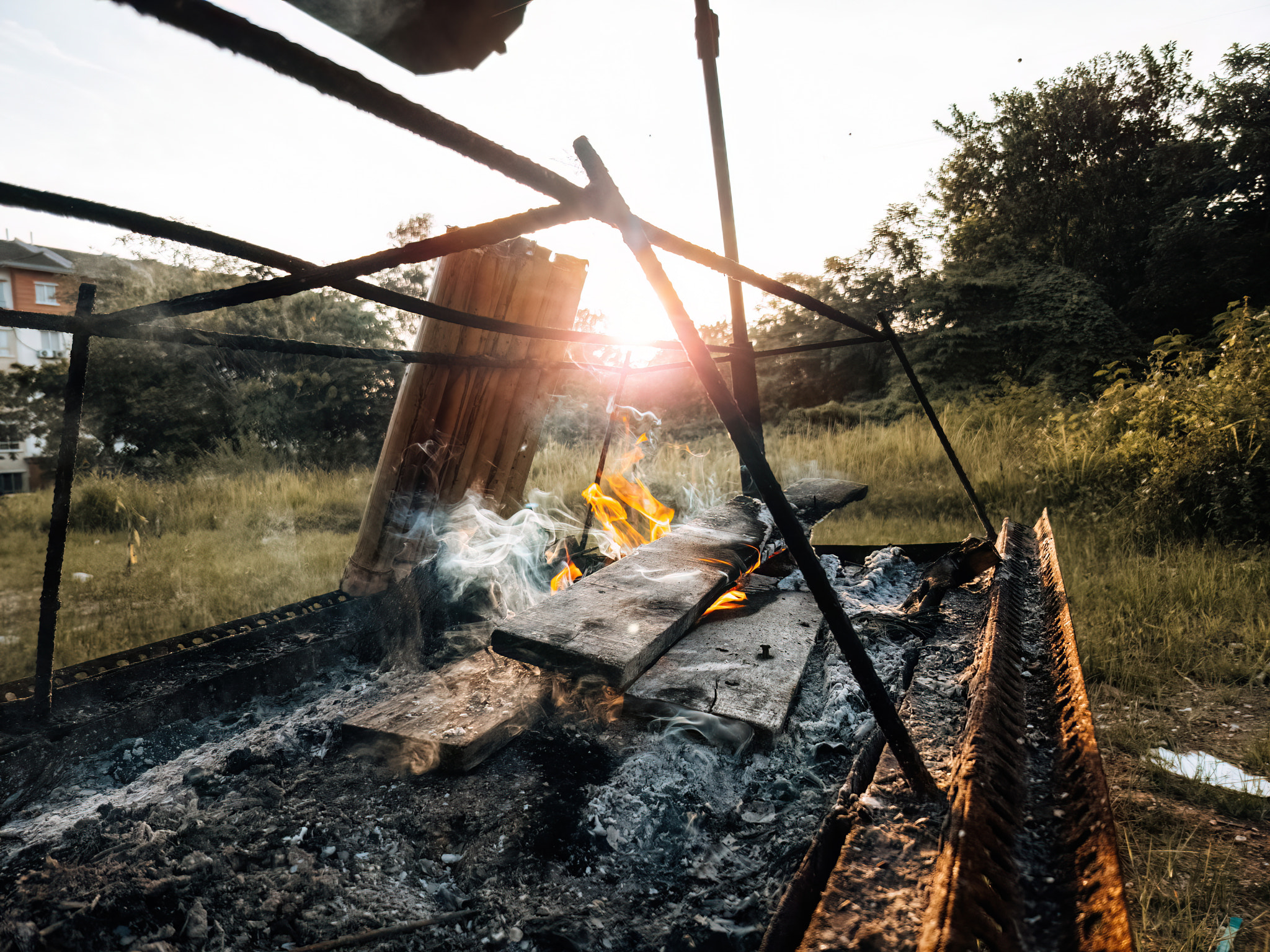 Fire burning the wood while cooking lemang on the sunset.