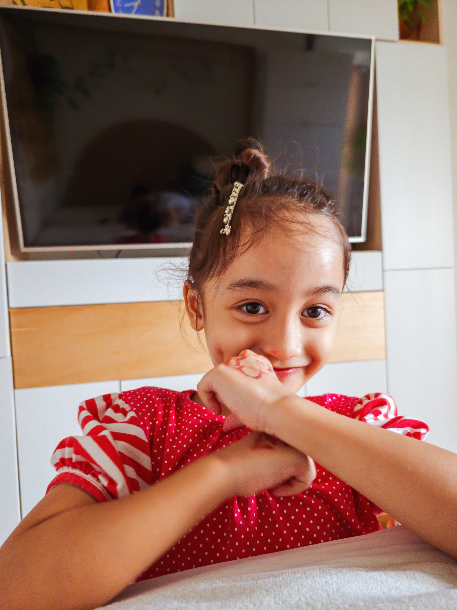 Portrait of cute girl making face while sitting at home