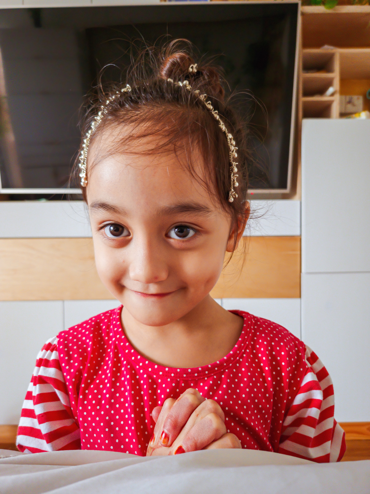 Portrait of cute girl sitting at home