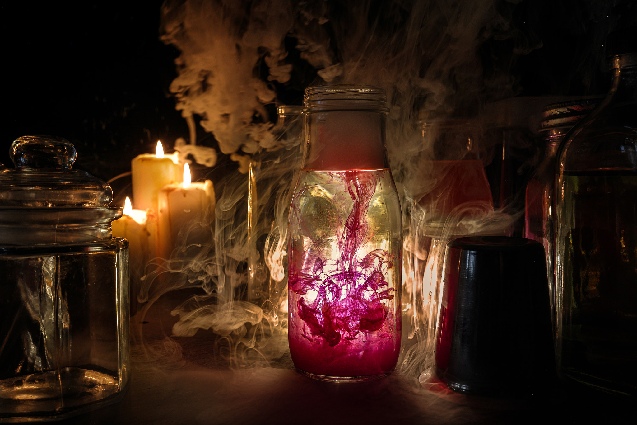 Alchemist laboratory mystery red ink flowing down bottle candle light smoke fog floating mistic flam