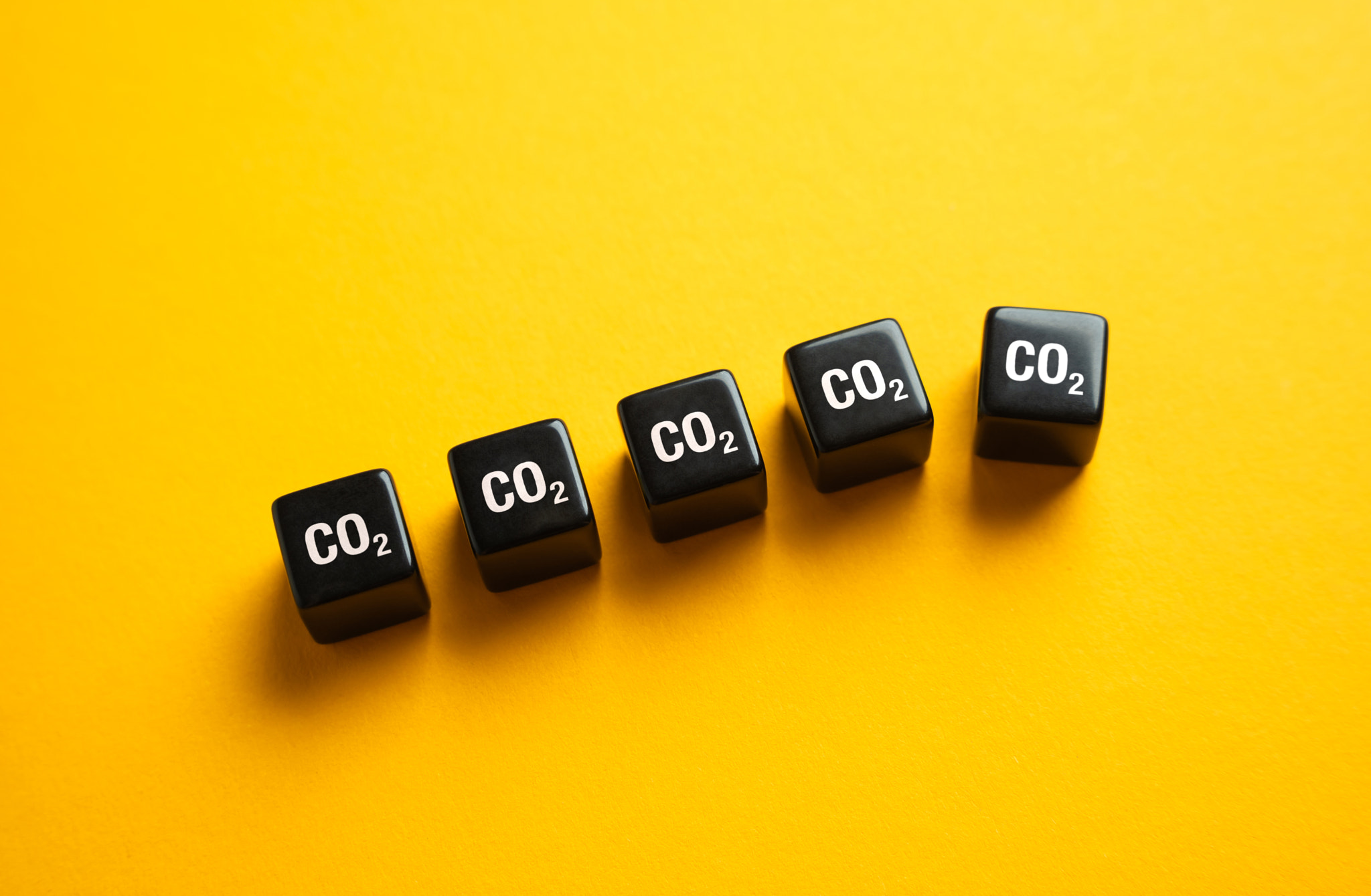 Blocks of cubic meters of CO2 one of which falls out. The concept of reducing greenhouse gas emissio