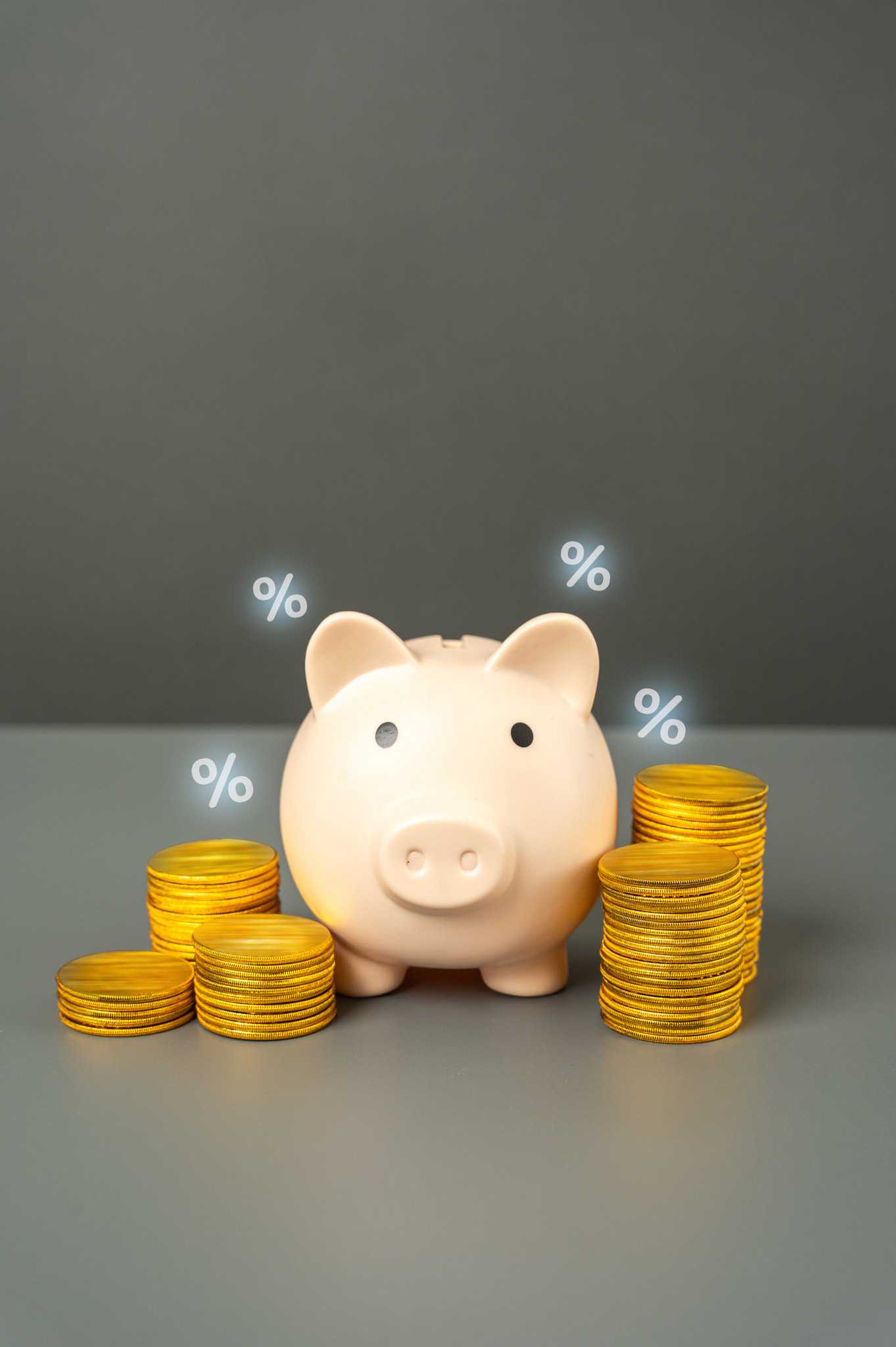 Saving money, piggy bank, coins and percentage symbols. Savings generate income. Interest growth.