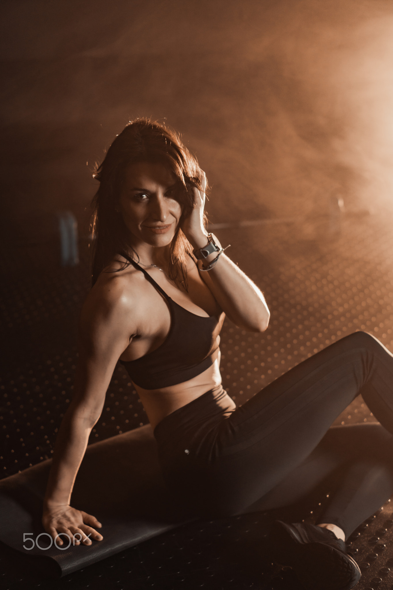 Fit and Empowered This dynamic portrait artfully showcases fitness illuminated by dramatic lighting