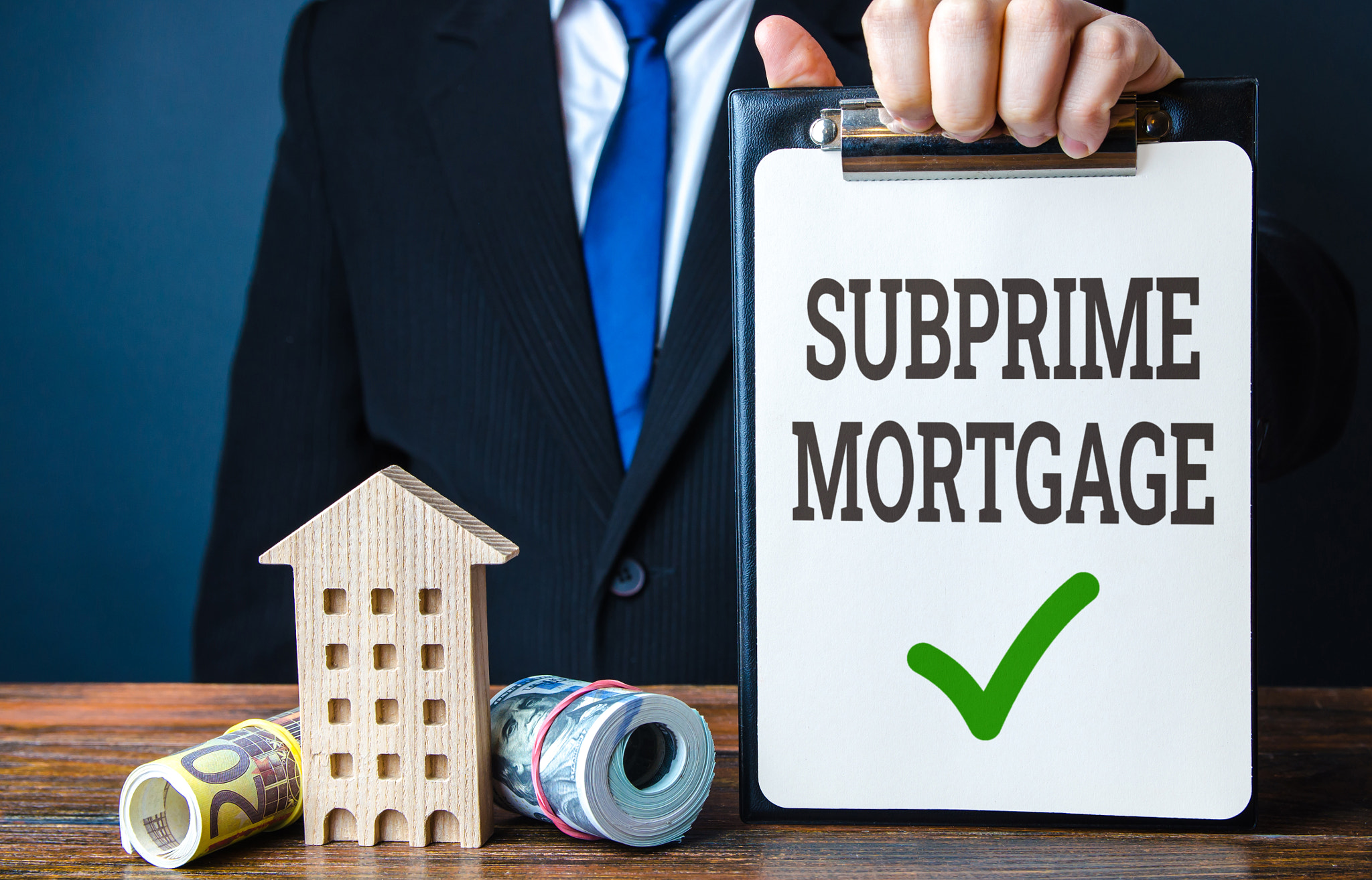 Subprime mortgage and a businessman with a house and money. Buy a house. High-risk lending practices