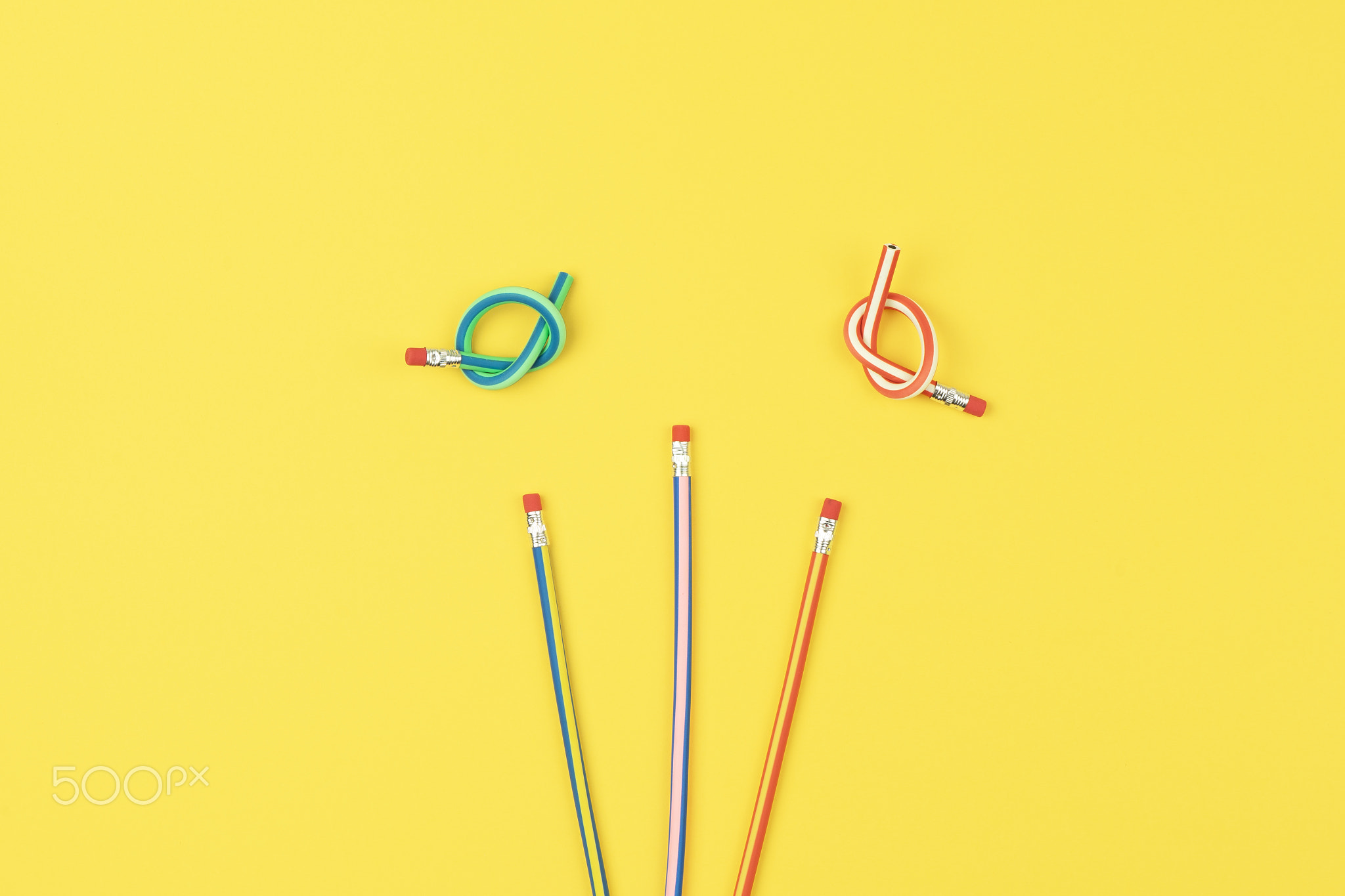 Colorful flex pencils on yellow background, increase creative
