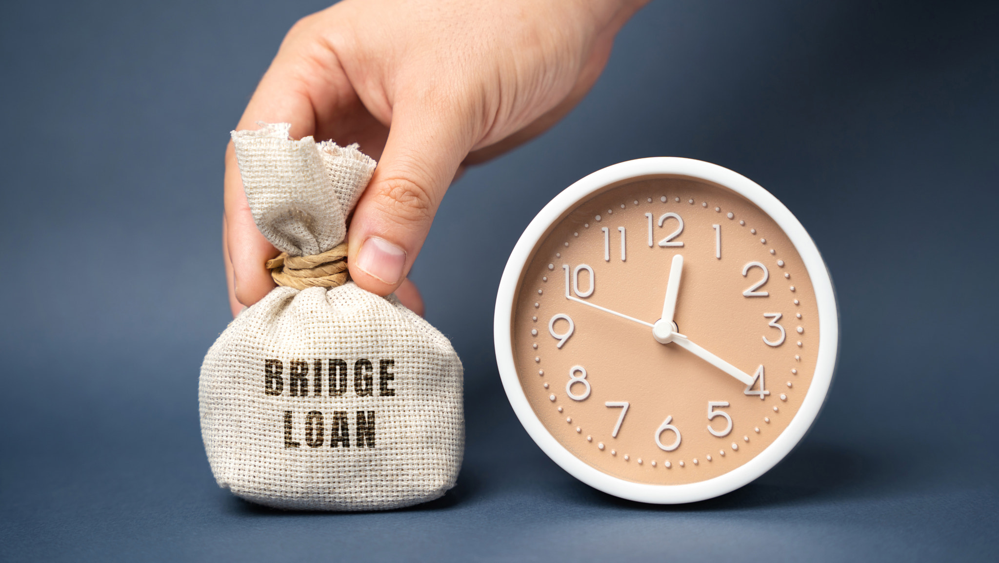 Money bag Bridge loan and clock. Short-term loan used until a person or company secures permanent fi