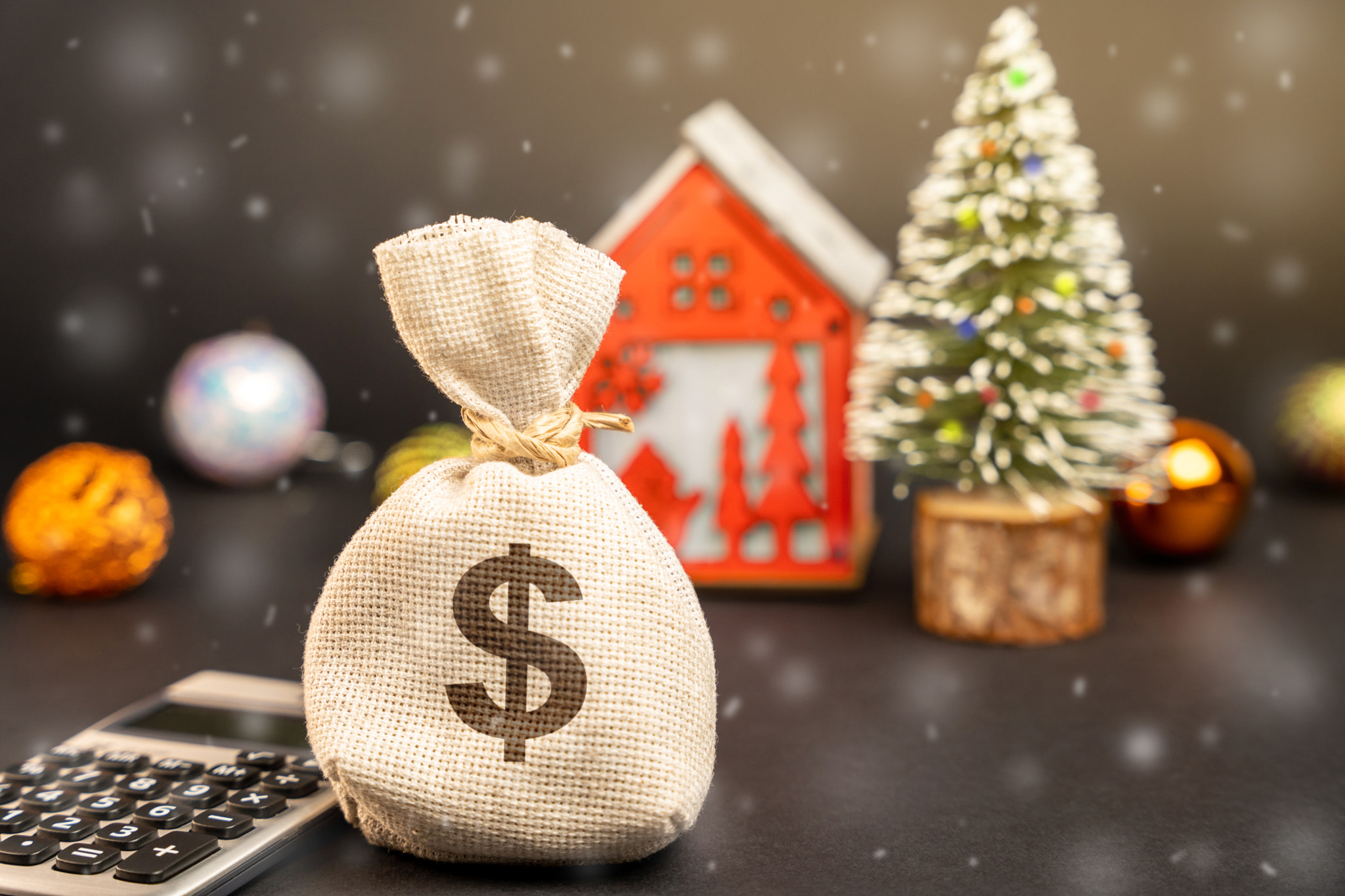 Dollars money bag on the background of a Christmas tree, house and snow. Accumulating money and plan