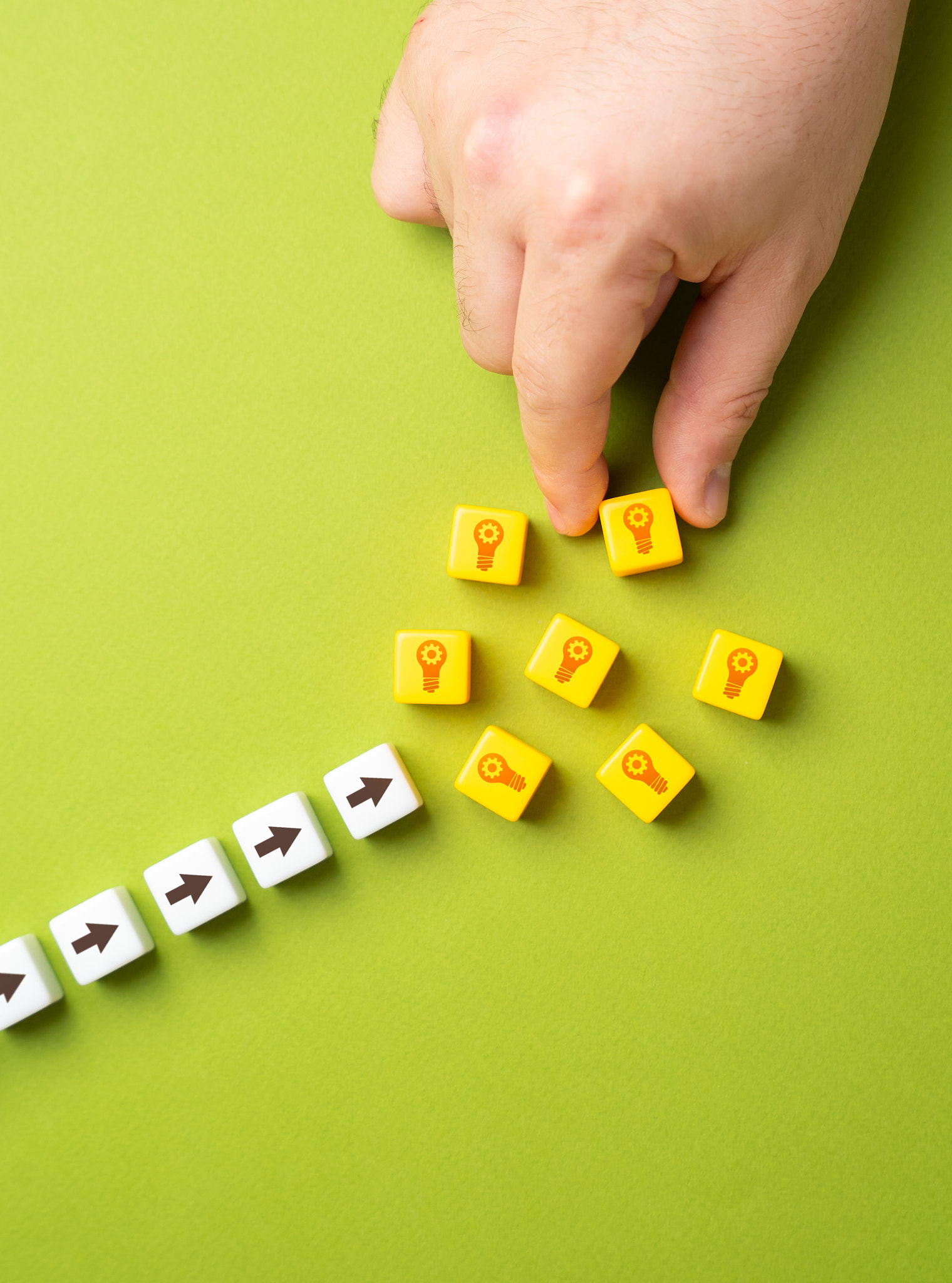 Hand puts blocks with light bulbs ideas. Concept of technological development and ingenuity. Patents