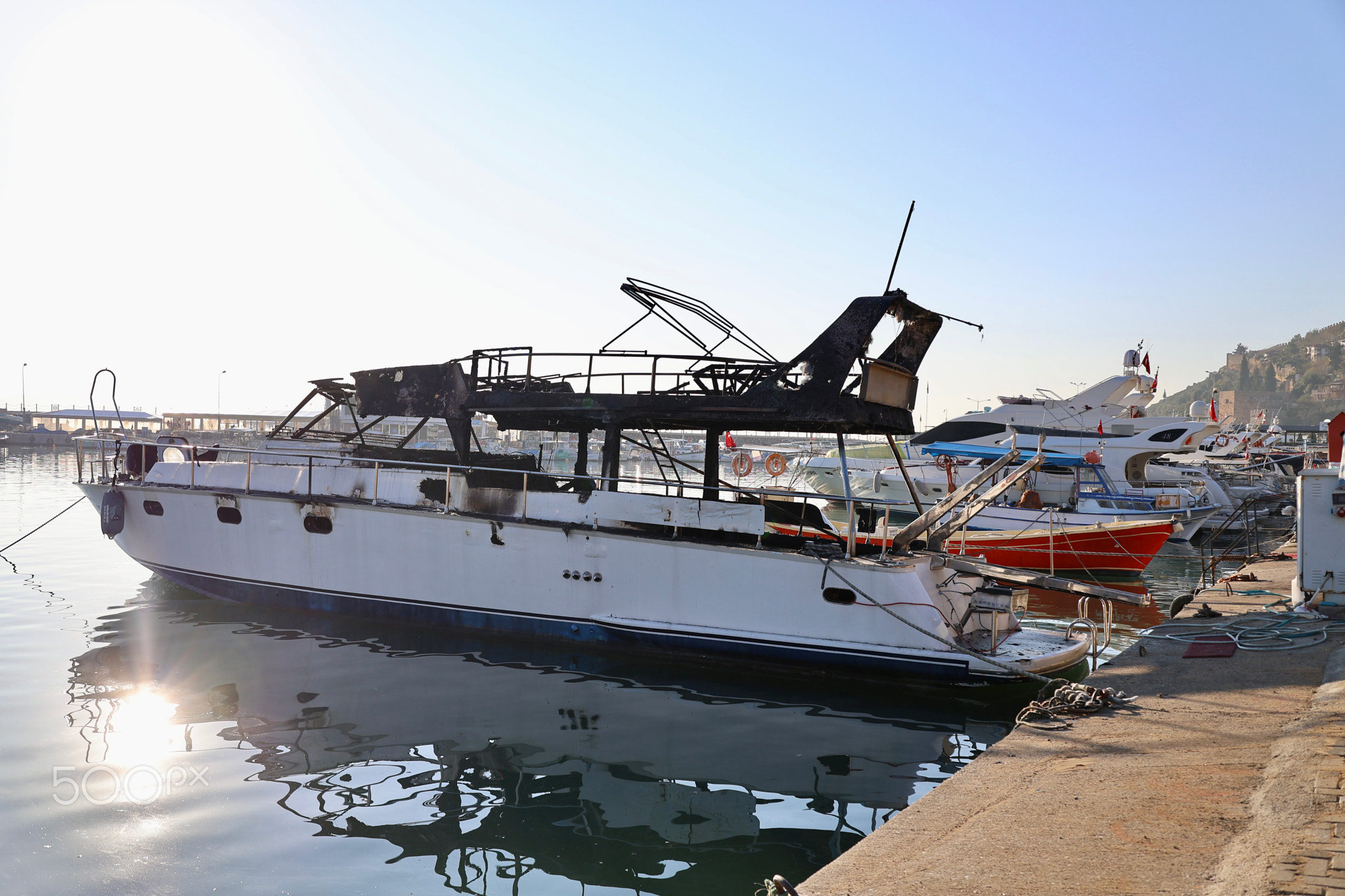Burned yacht docked