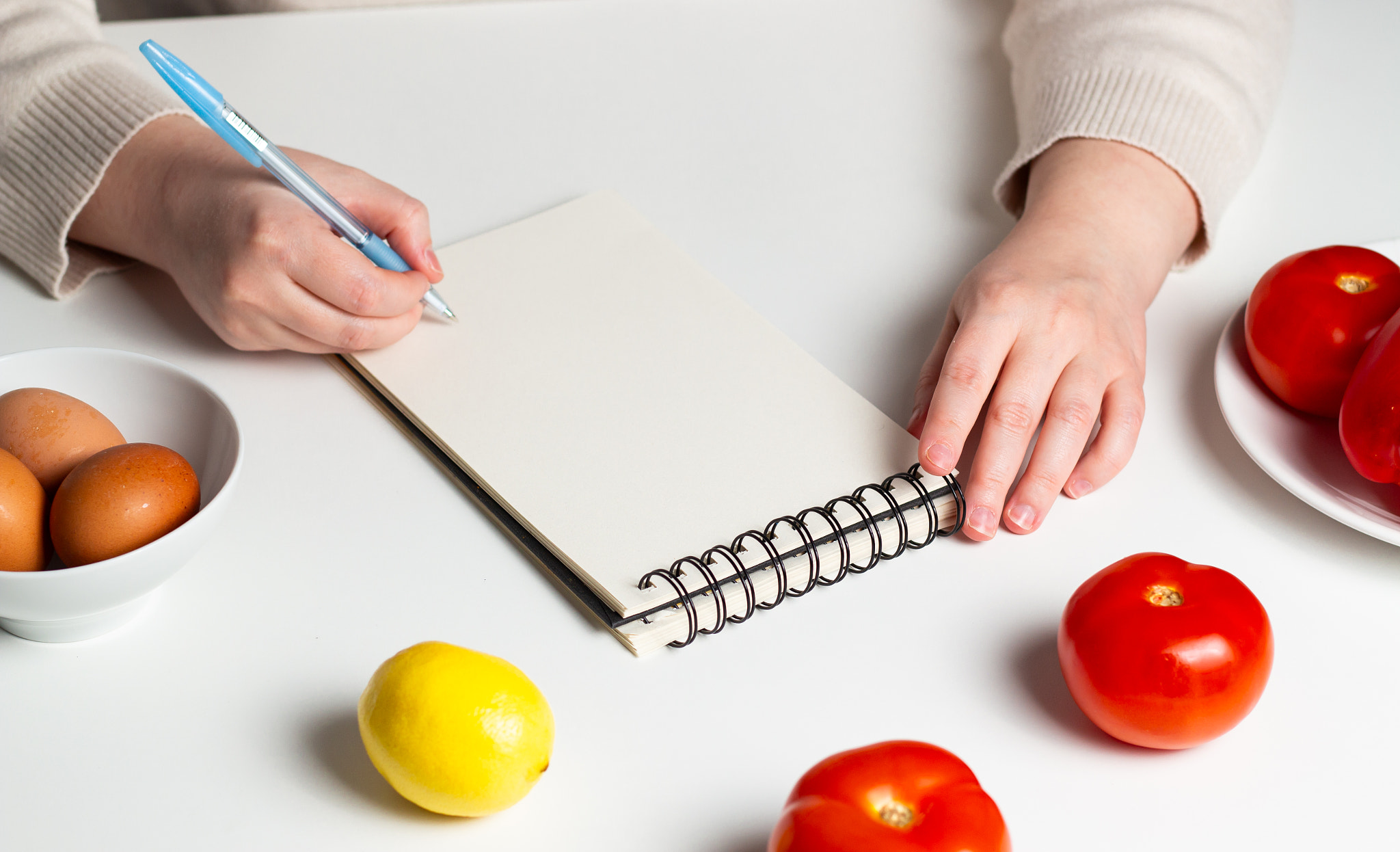 Healthy food planning concept. Mock up of diet plan. Woman creating diet menu for weight loss.