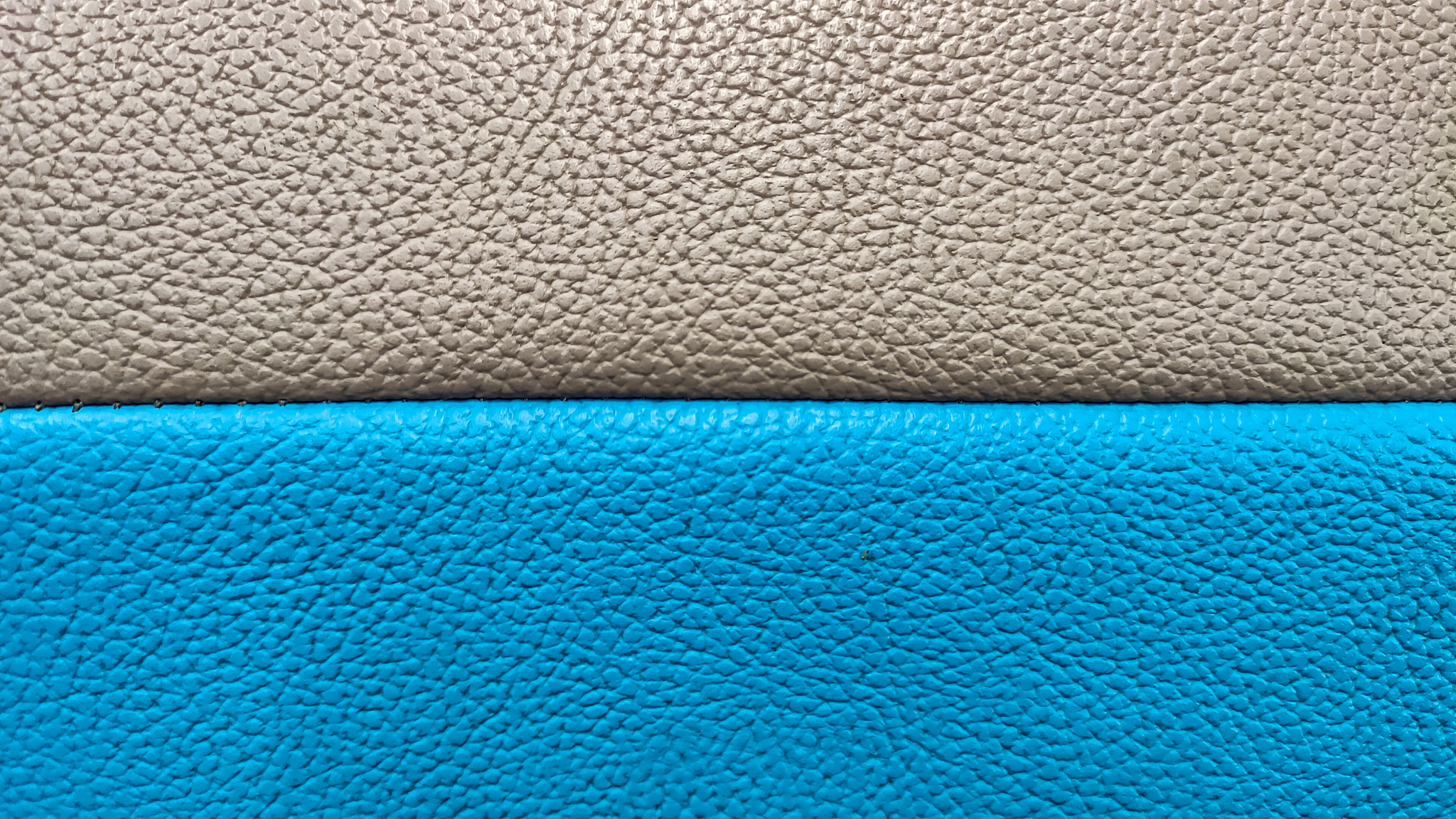 White and light blue faux leather connected by stitching