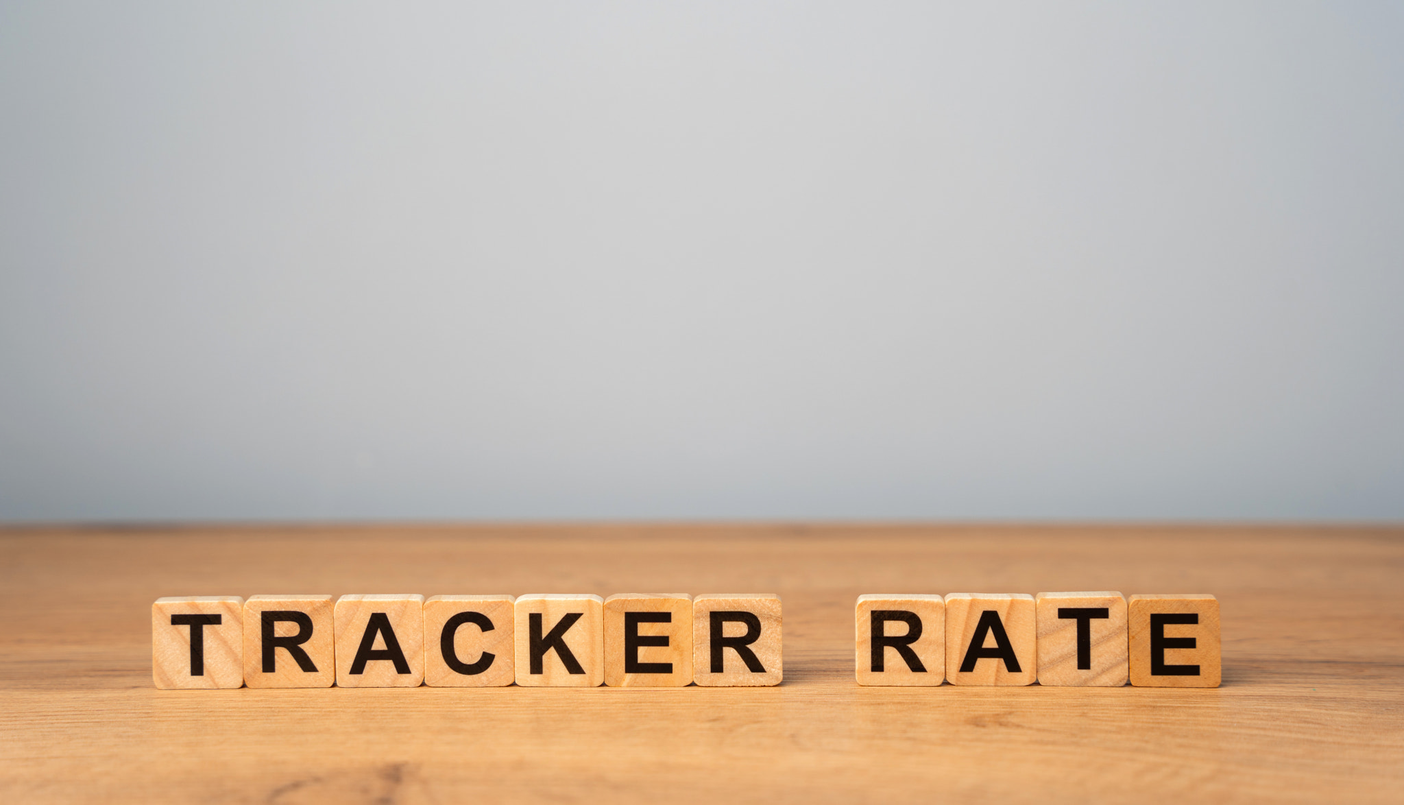 Wooden blocks with word Tracker rate. Type of variable interest rate on a loan or mortgage that foll