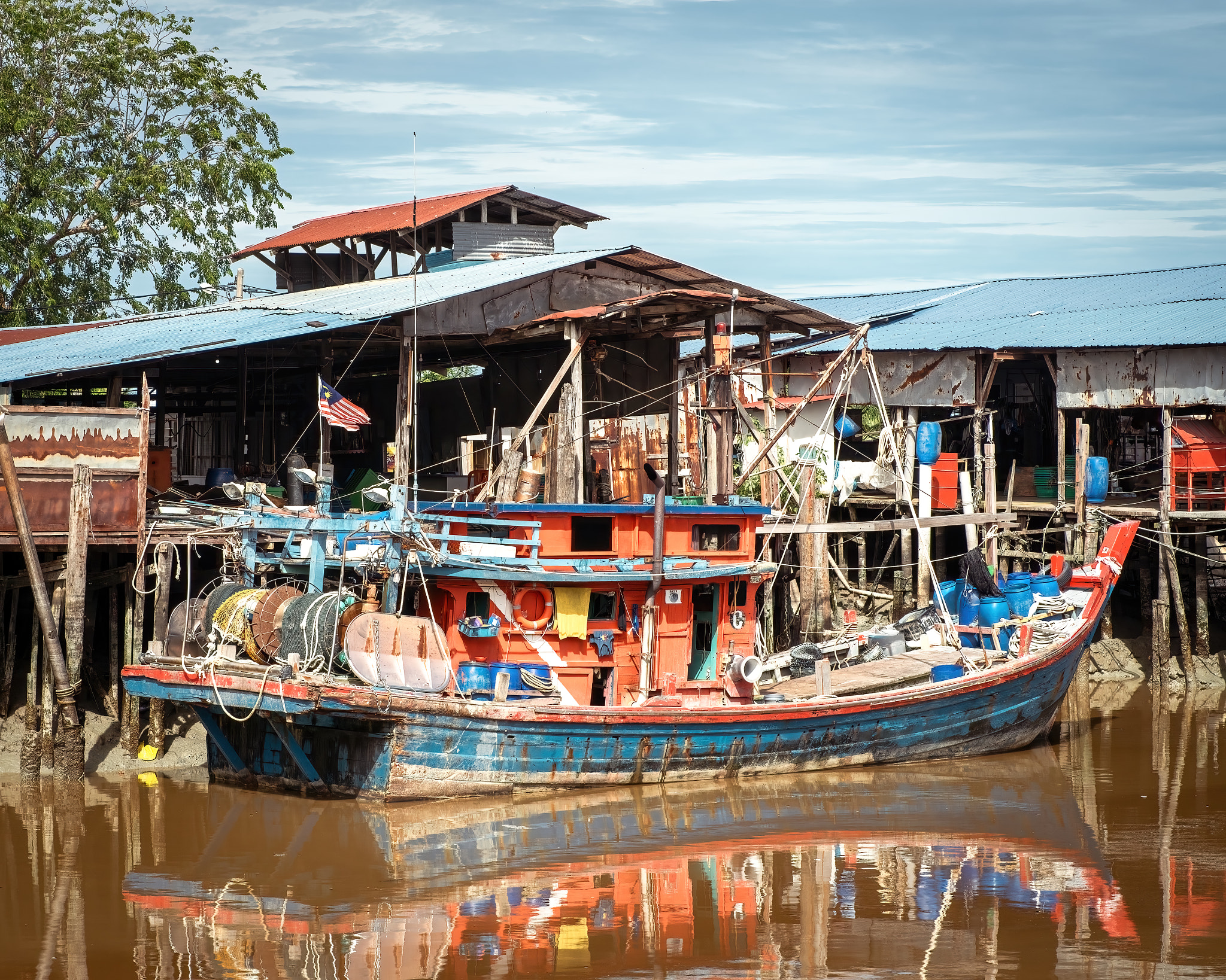 Sekinchan, Malaysia - Oct 6, 2022 Colorful fisherman's boat at the jetty.
