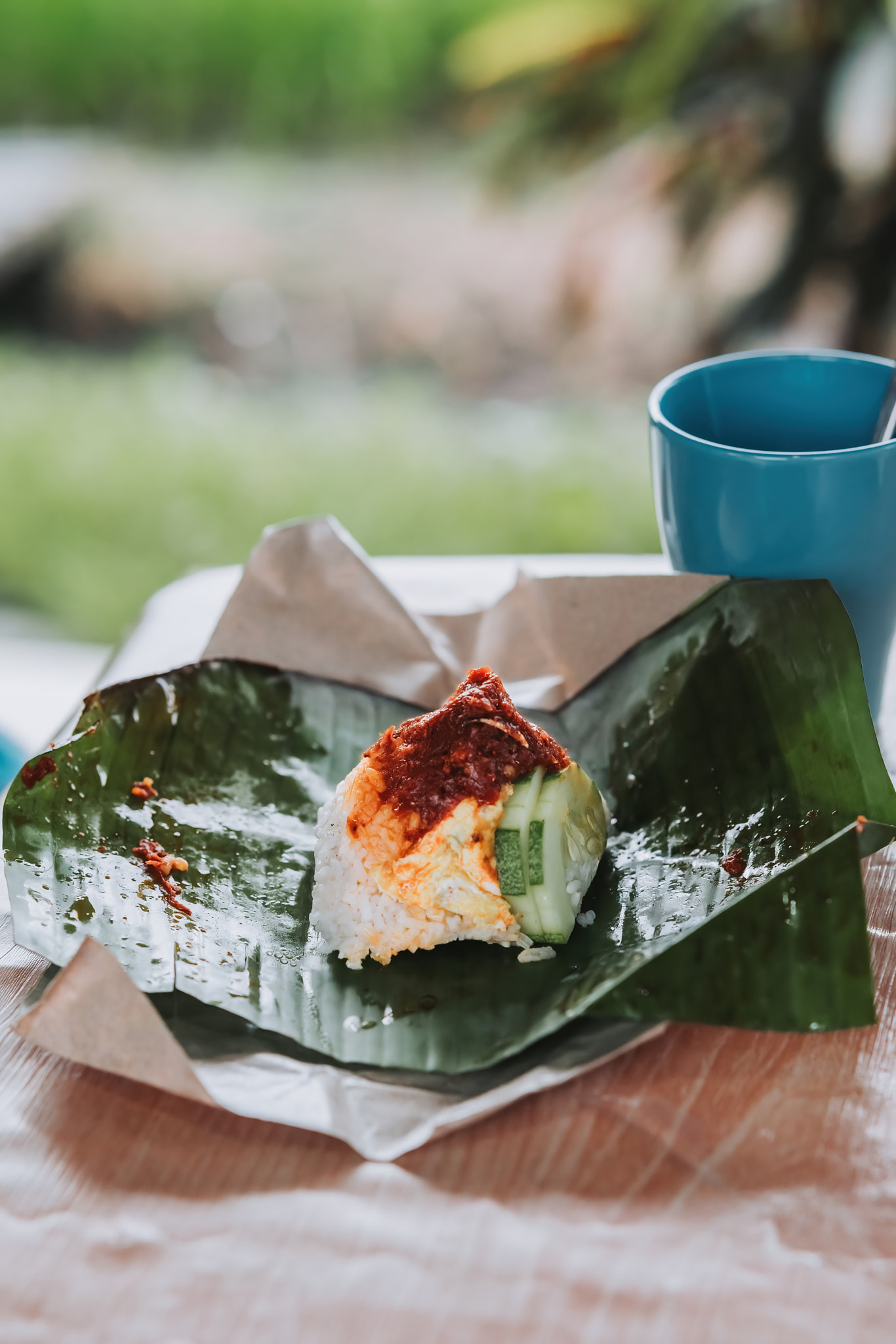 Nasi Lemak opened with banana leaf and a mug on the side. Staple breakfast for Malaysian.