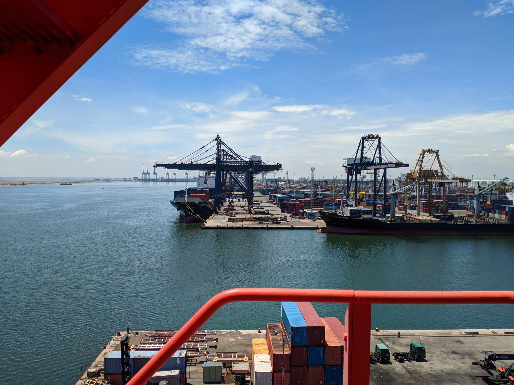 Aerial view of container ship in sea against sky