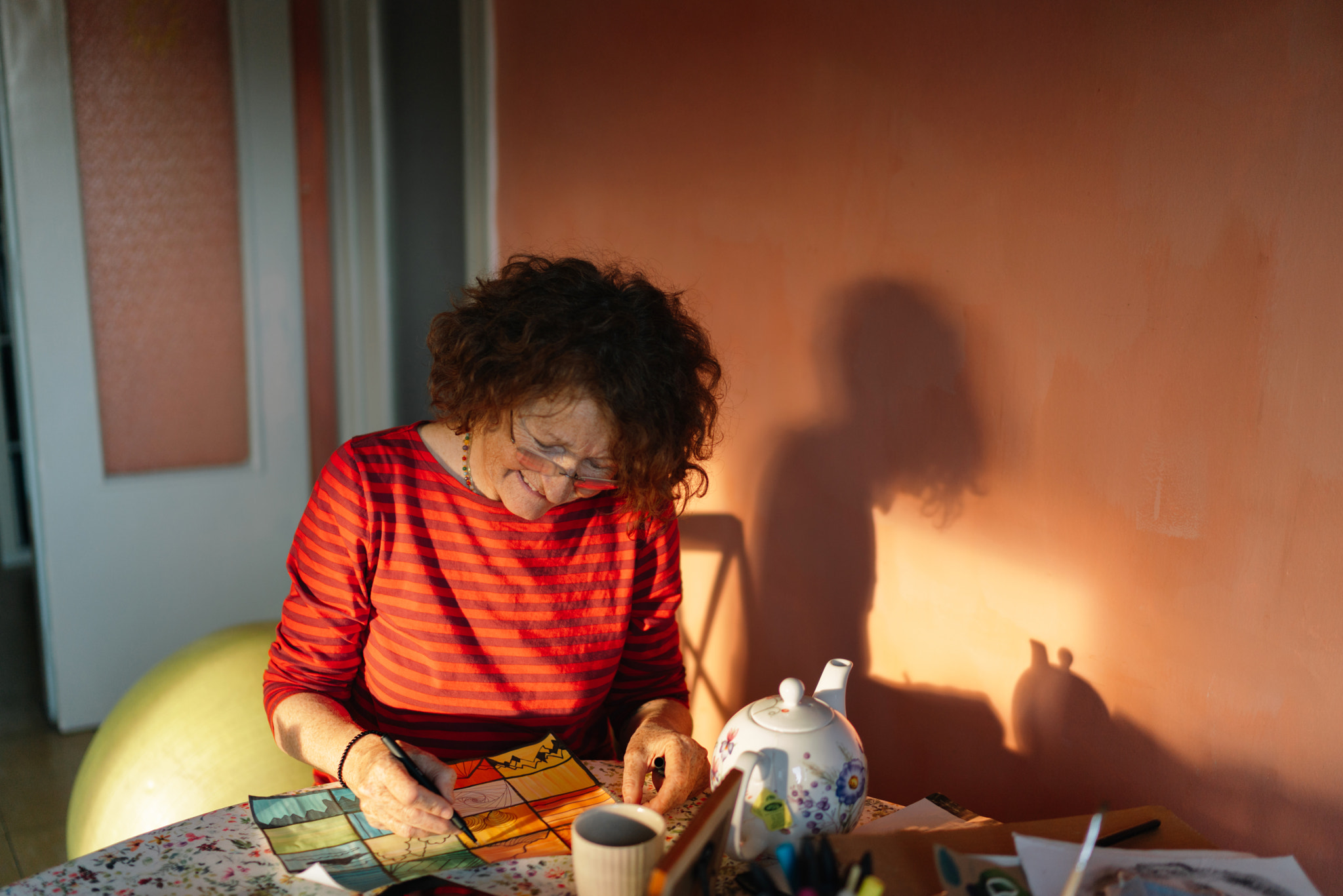 Senior woman painting on a paper