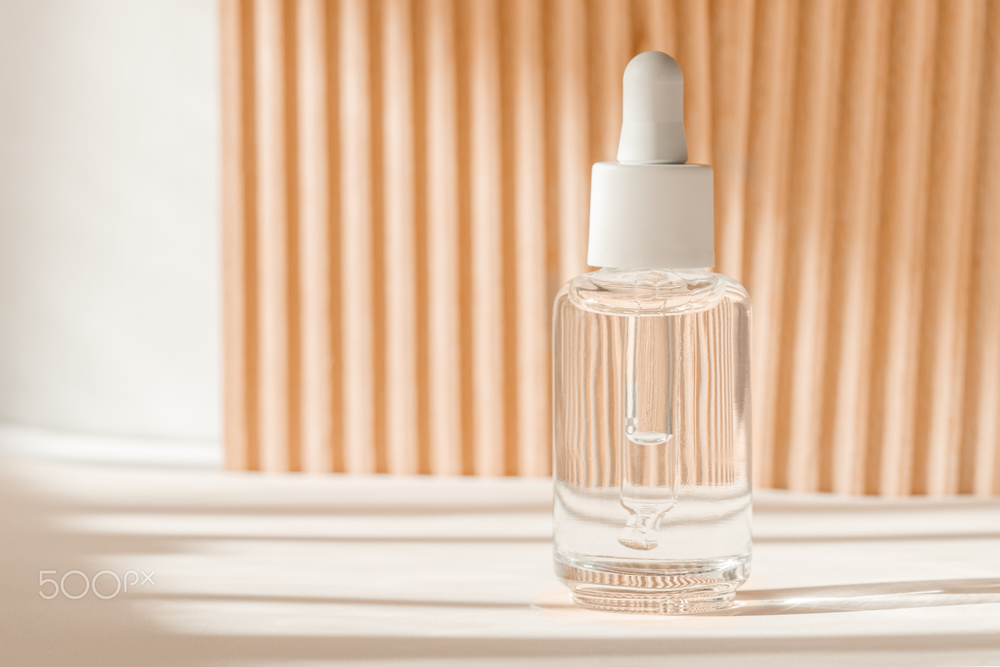 Serum cosmetic bottle, hyaluronic acid on brown background. Serum