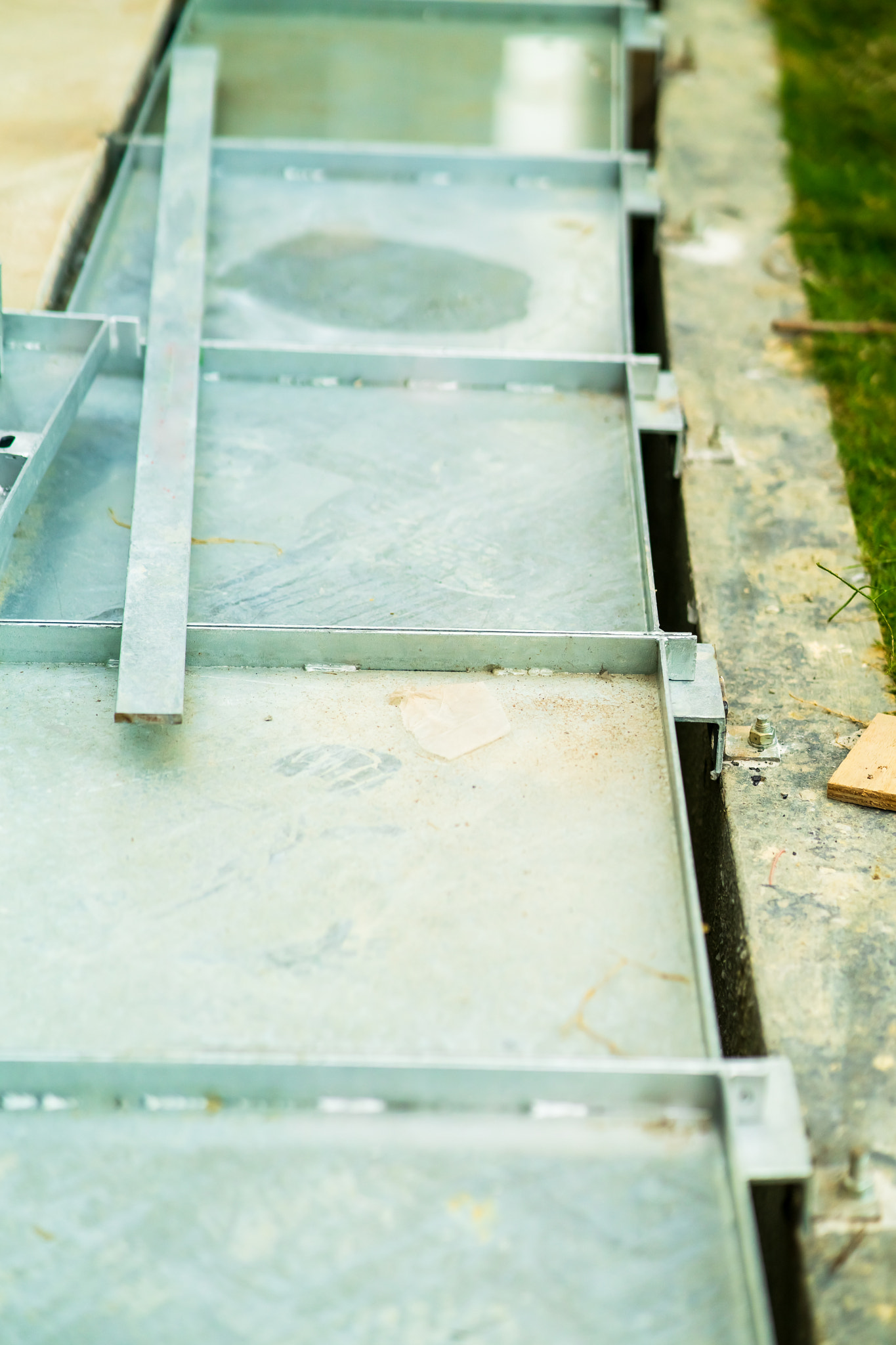 metal water drain or ditch in a construction site. Gutters drain grate, drain cover. garden drains -