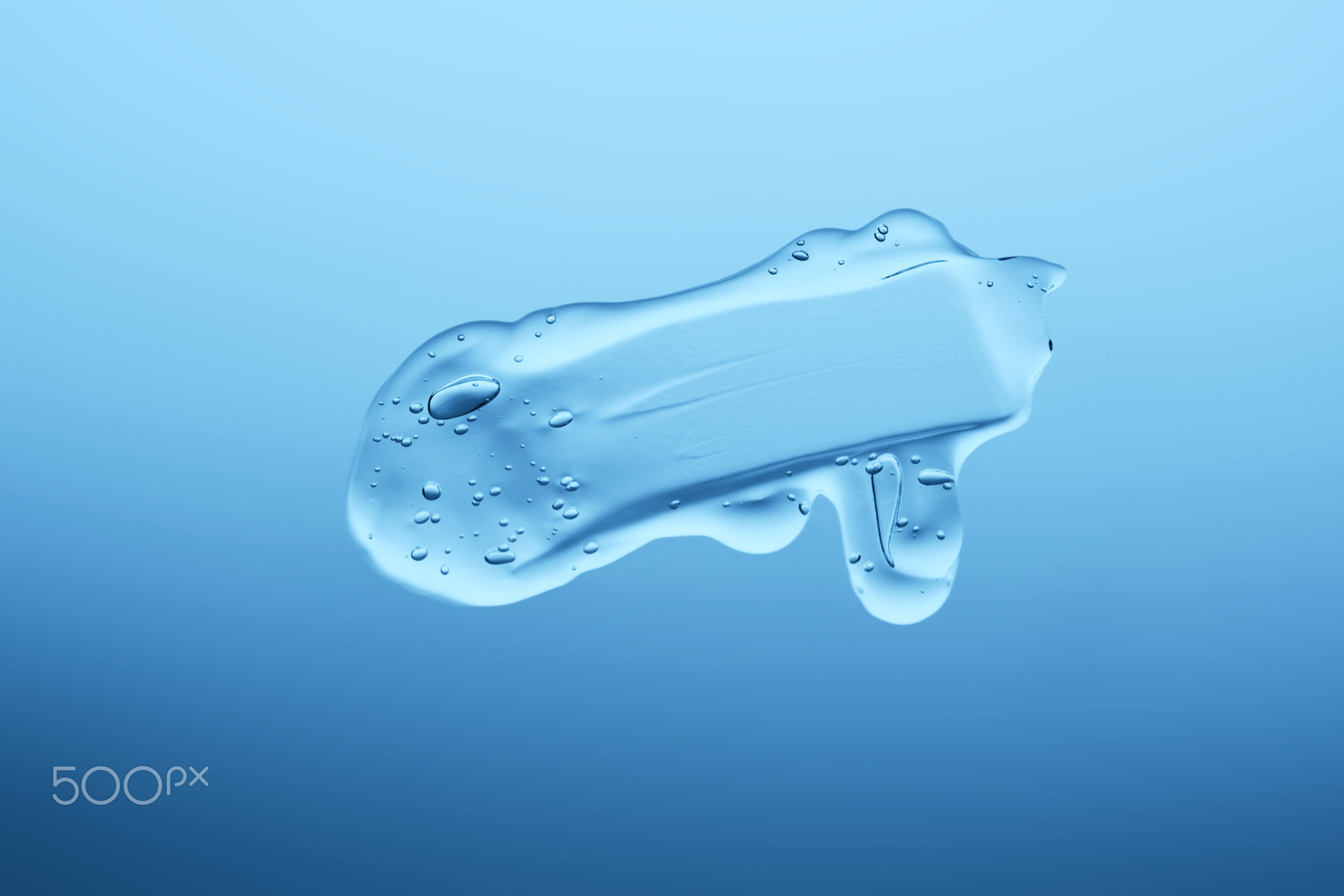 Gel cosmetic texture on a blue background.