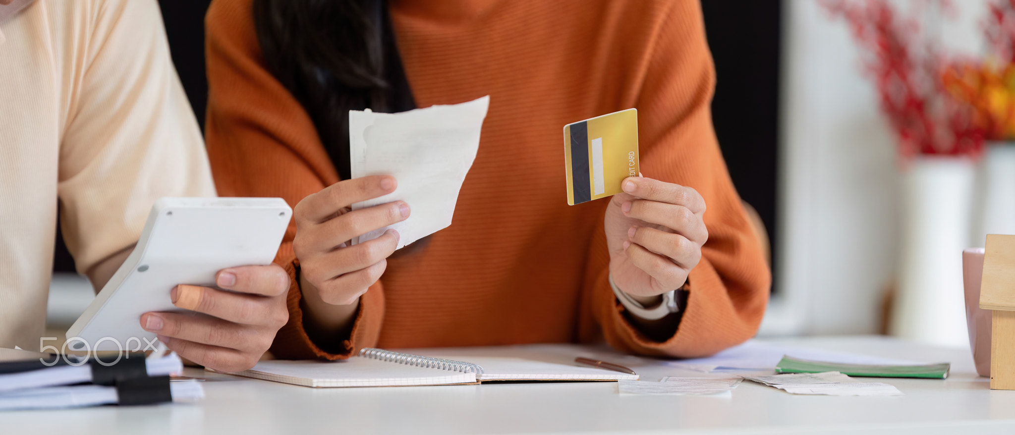 Couple analyzing bills and payment methods, focusing on financial