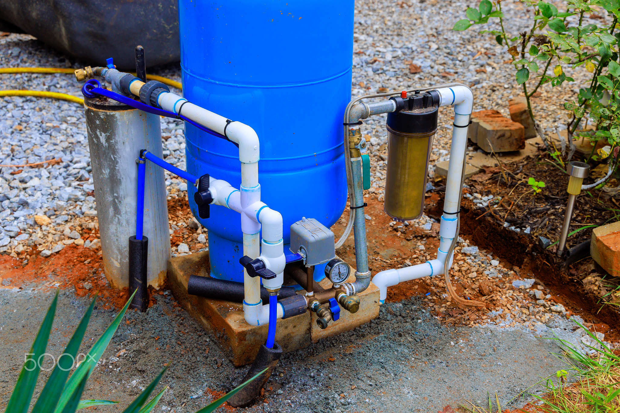 Water artesian well system setup in residential outdoor setting for