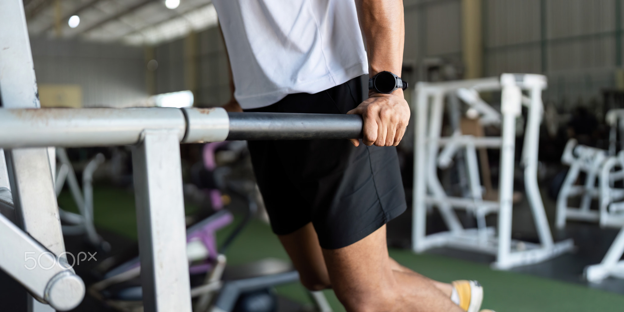 Wellness through Strength Training. Man performing dips in gym for